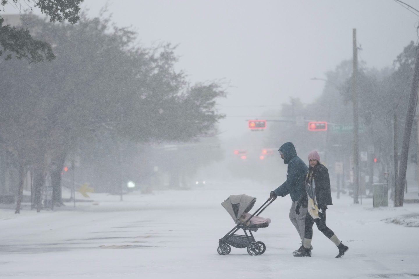 People take a walk in the neighborhood on Jan. 21, 2025, in Houston.