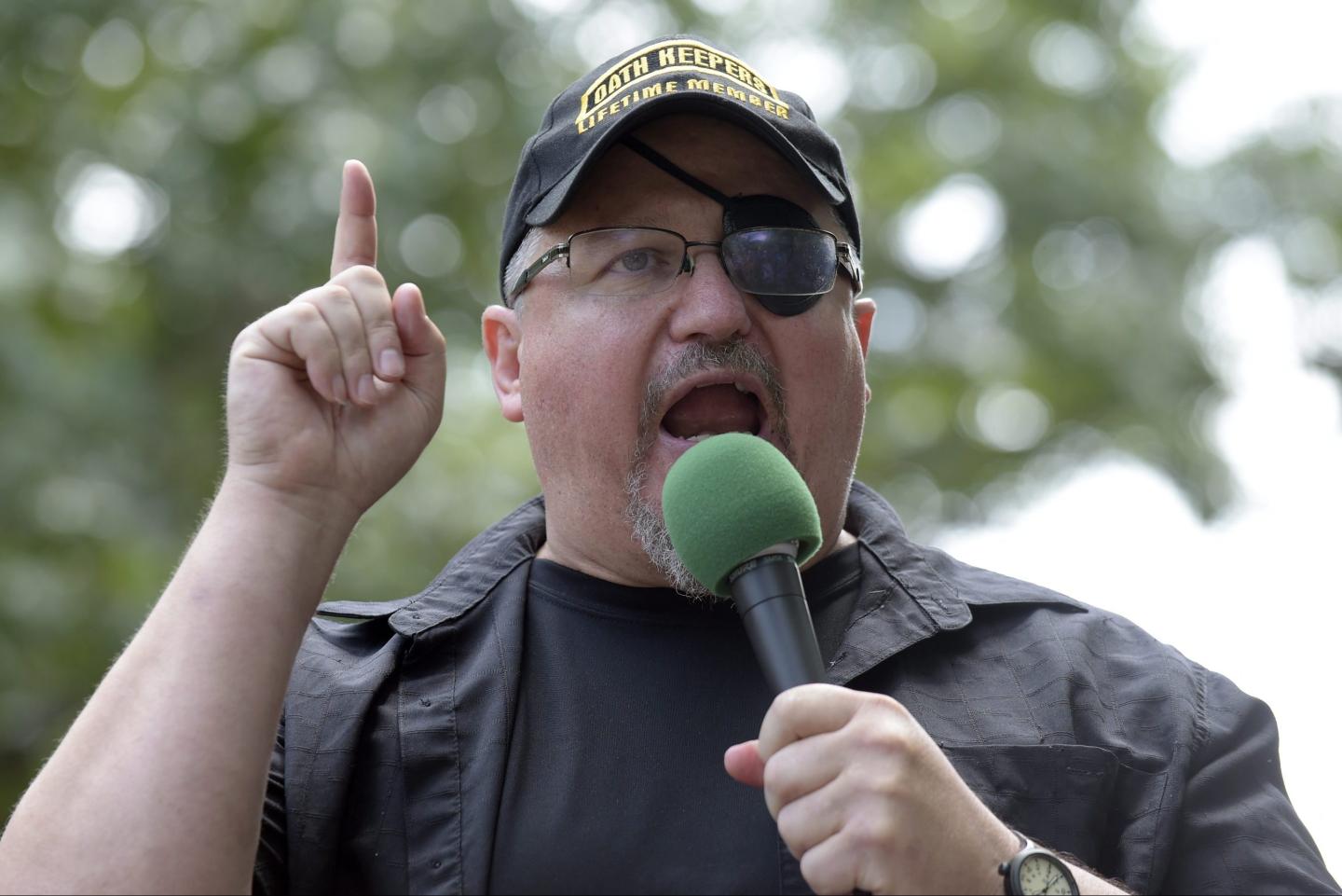 Oath Keepers founder Stewart Rhodes yells into a microphone
