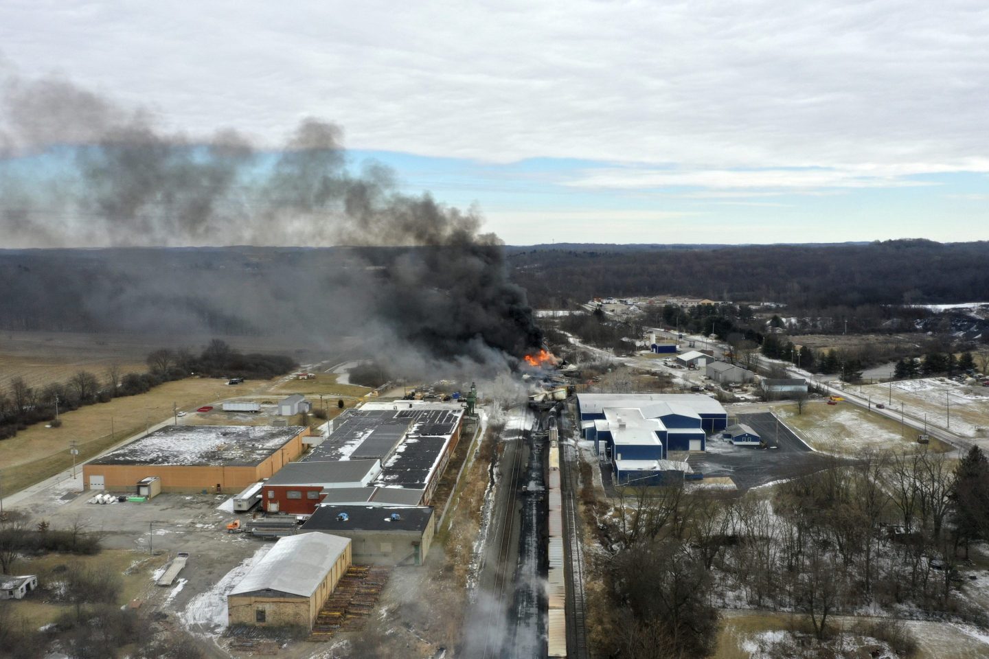 The Norfolk Southern train derailment in East Palestine, Ohio, shows black smoke pouring into the air after the crash