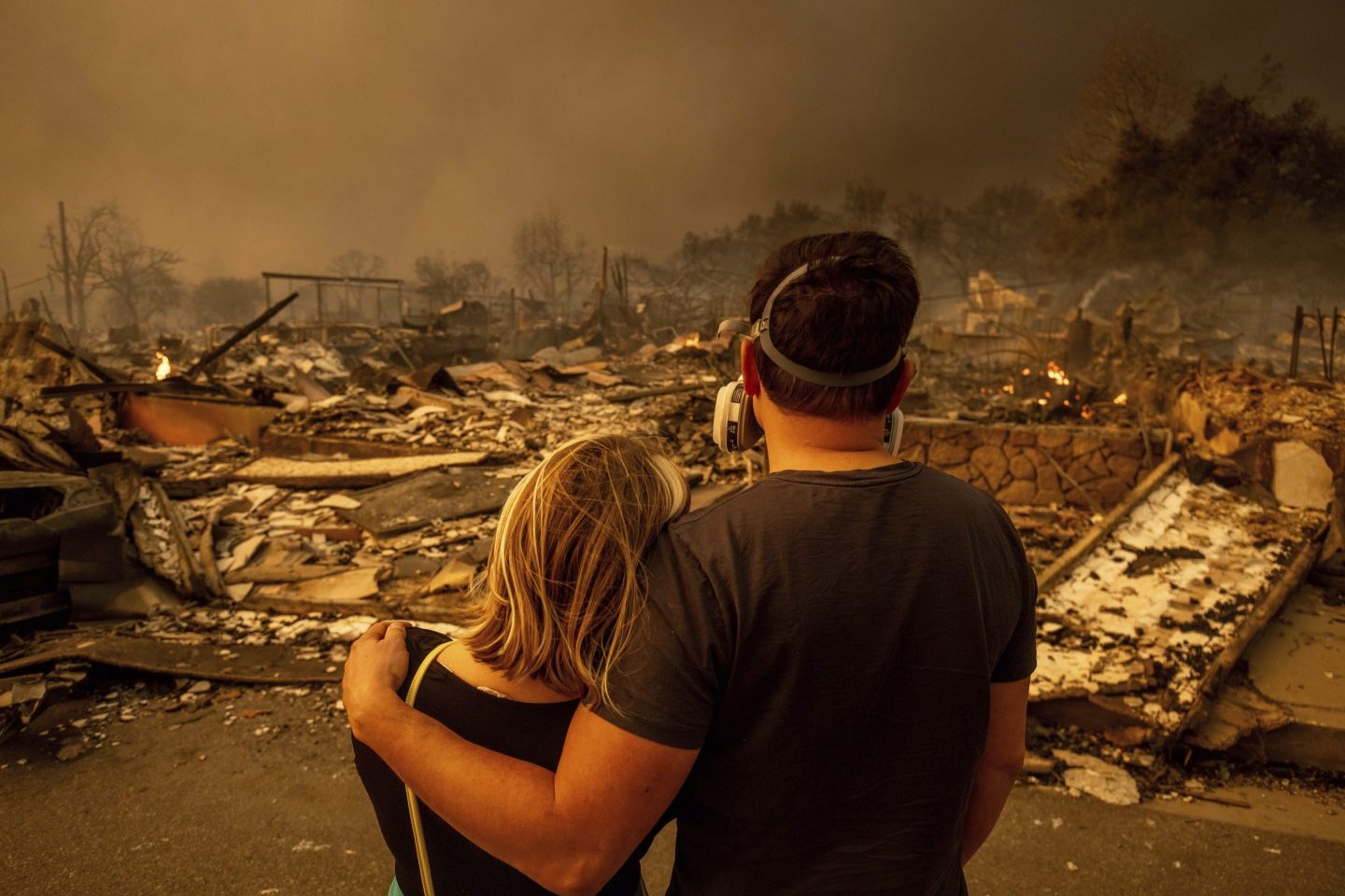 Megan Mantia, left, and her boyfriend Thomas, return to Mantia's fire-damaged home after the Eaton Fire swept through the area, on Jan. 8, 2025, in Altadena, Calif.