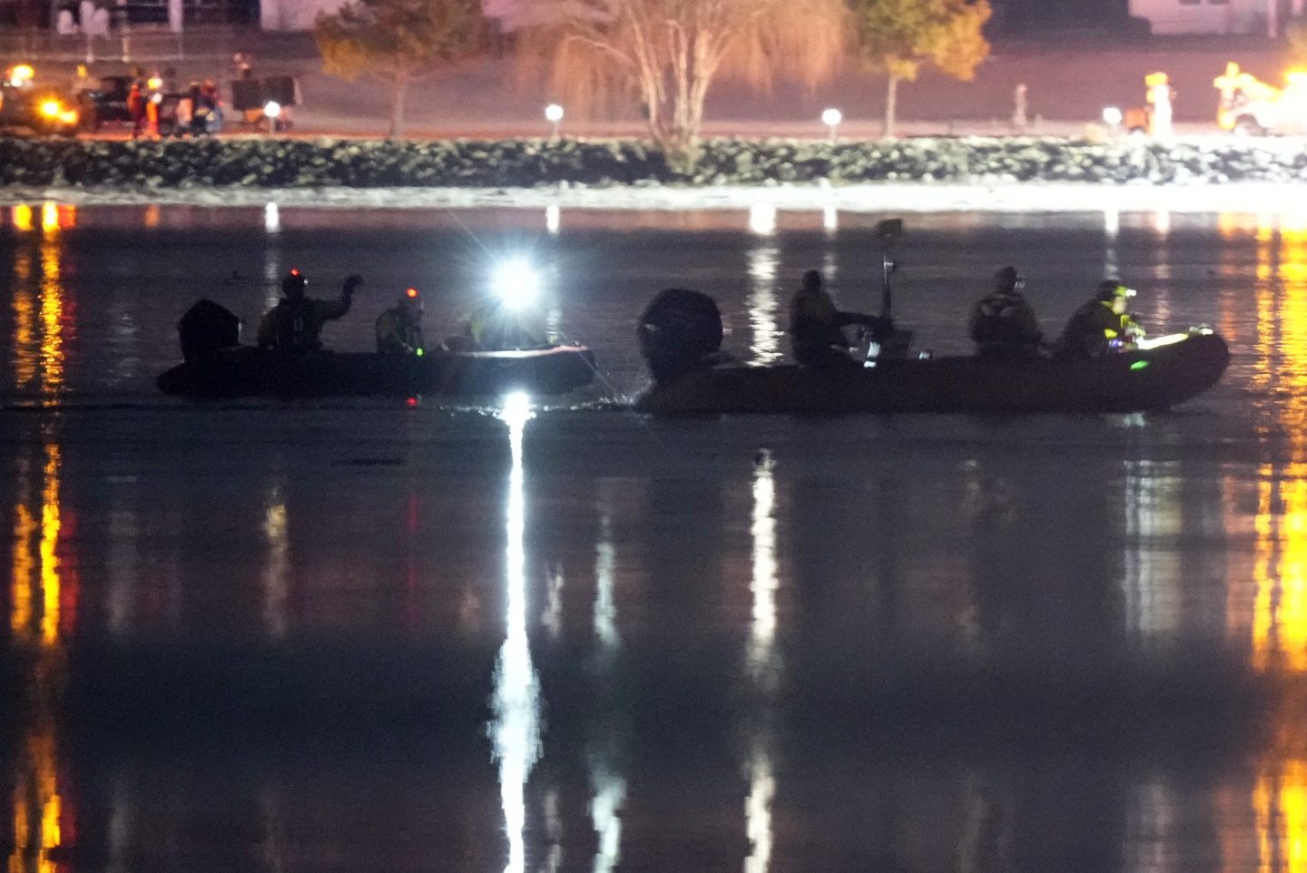 Boats work the scene in the Potomac River near Ronald Reagan Washington National Airport, Jan. 30, 2025, in Arlington, Va.
