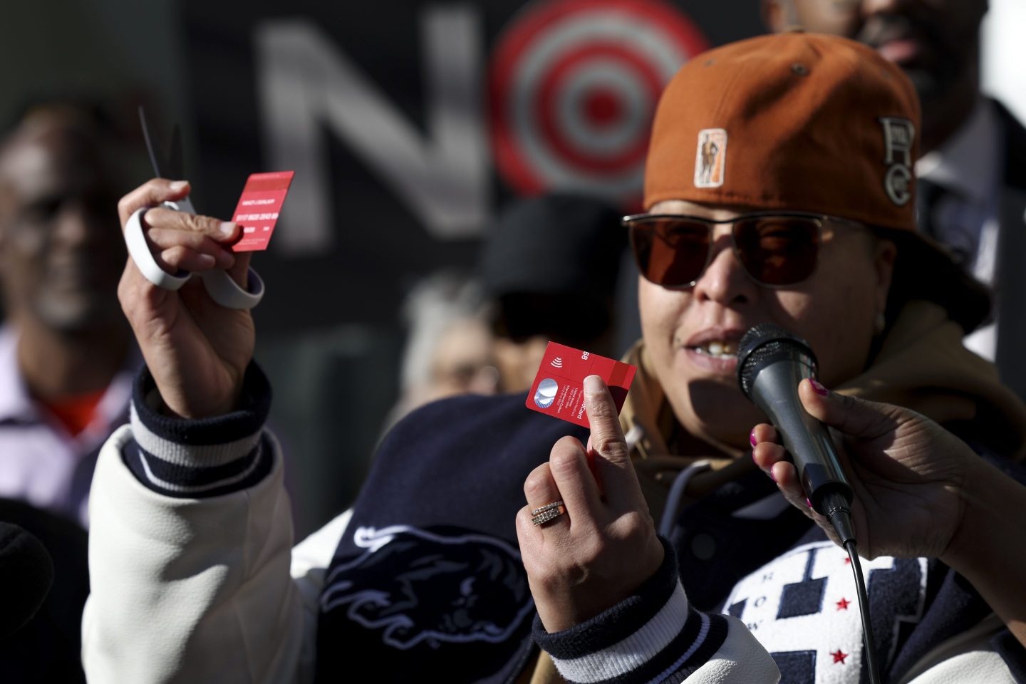 A community advocate cuts a Target credit card during a news conference outside Target Corporation's headquarters on Jan. 30, 2025, in Minneapolis.