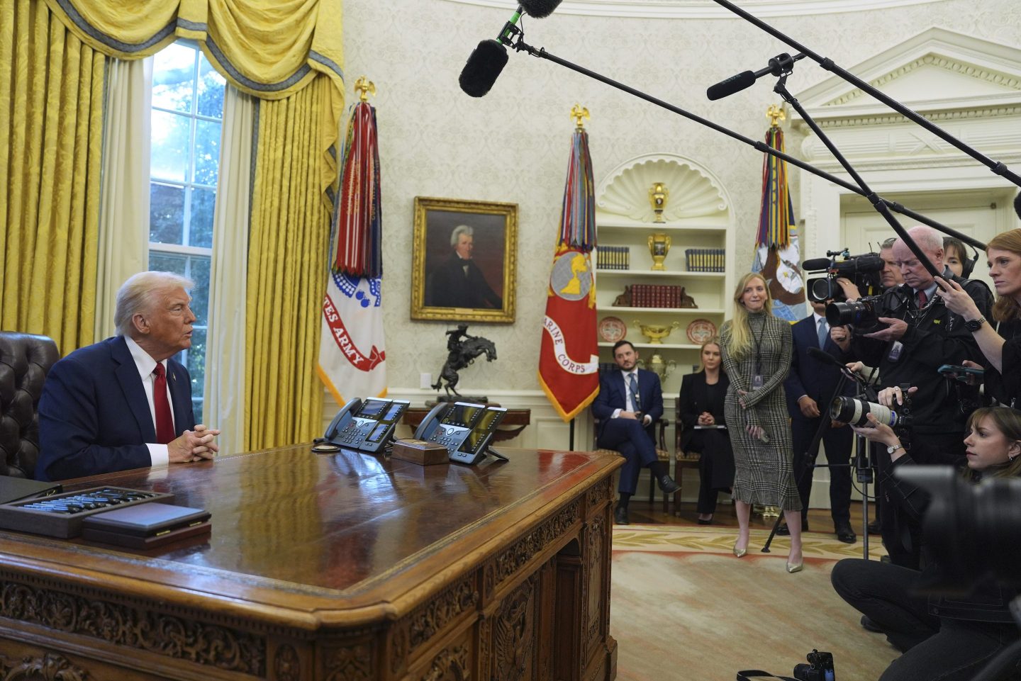 President Donald Trump talks with reporters as he signs executive orders in the Oval Office at the White House, on Jan. 30, 2025, in Washington.
