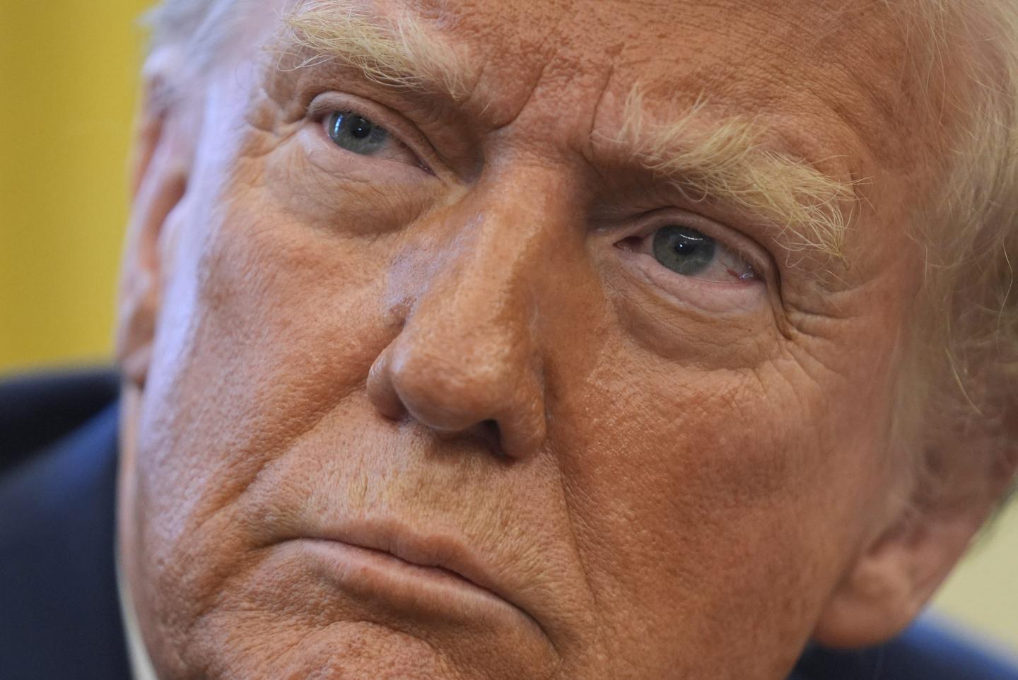 President Donald Trump listens to a question as he signs executive orders in the Oval Office at the White House, Thursday, Jan. 30, 2025, in Washington.