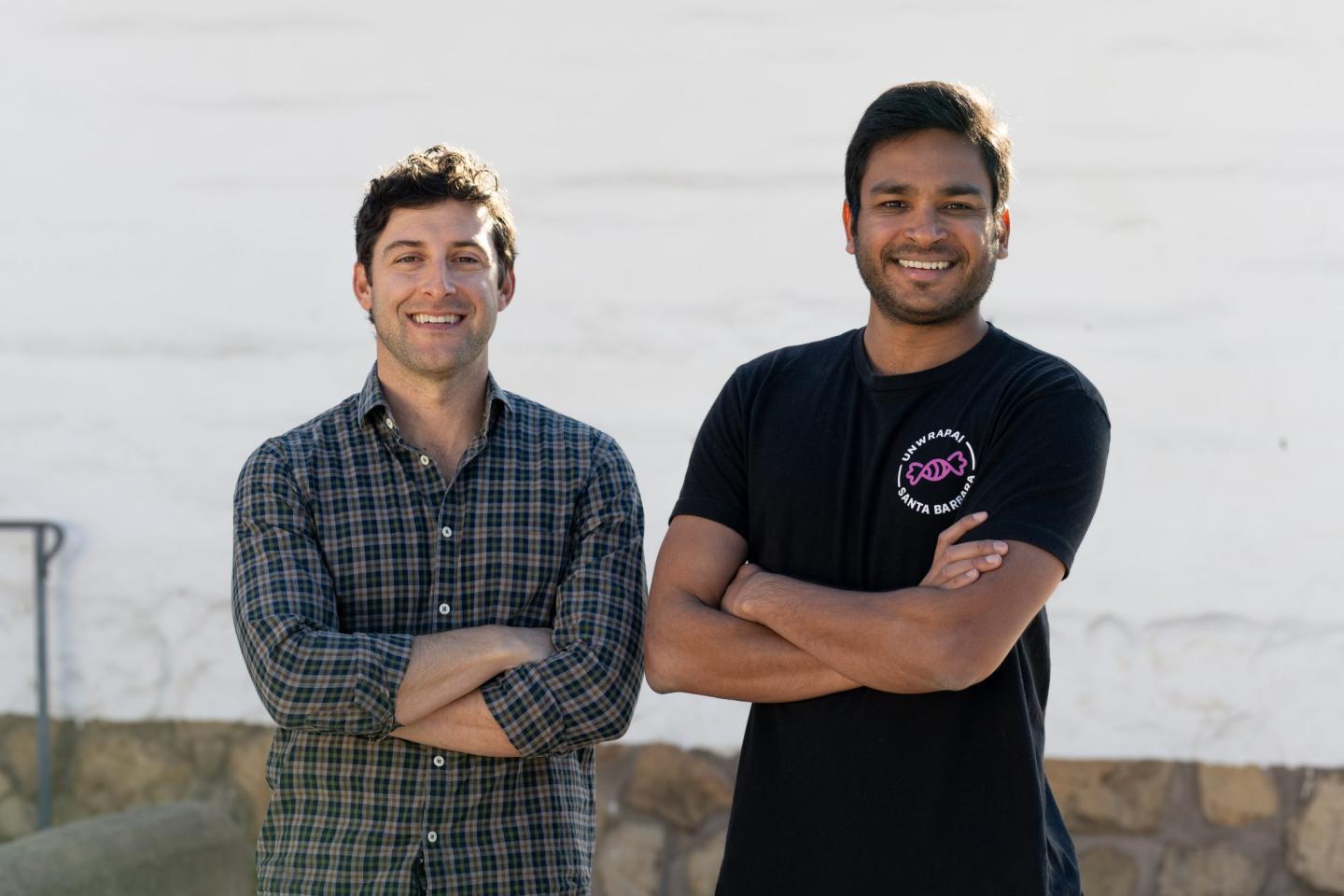 two men pose for a photo portrait outdoors
