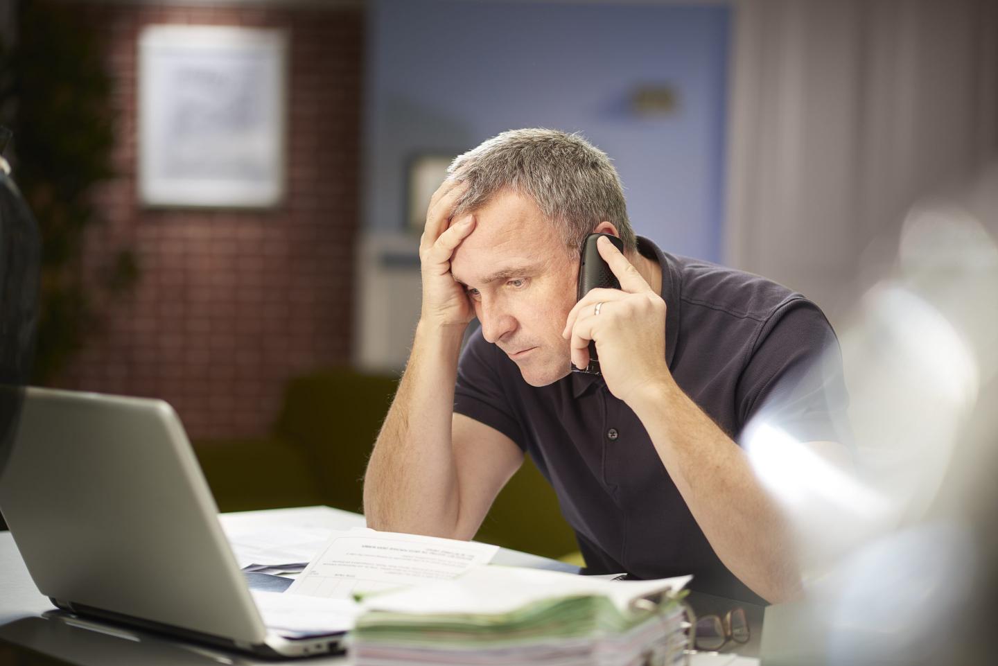 Person on the phone at their computer.