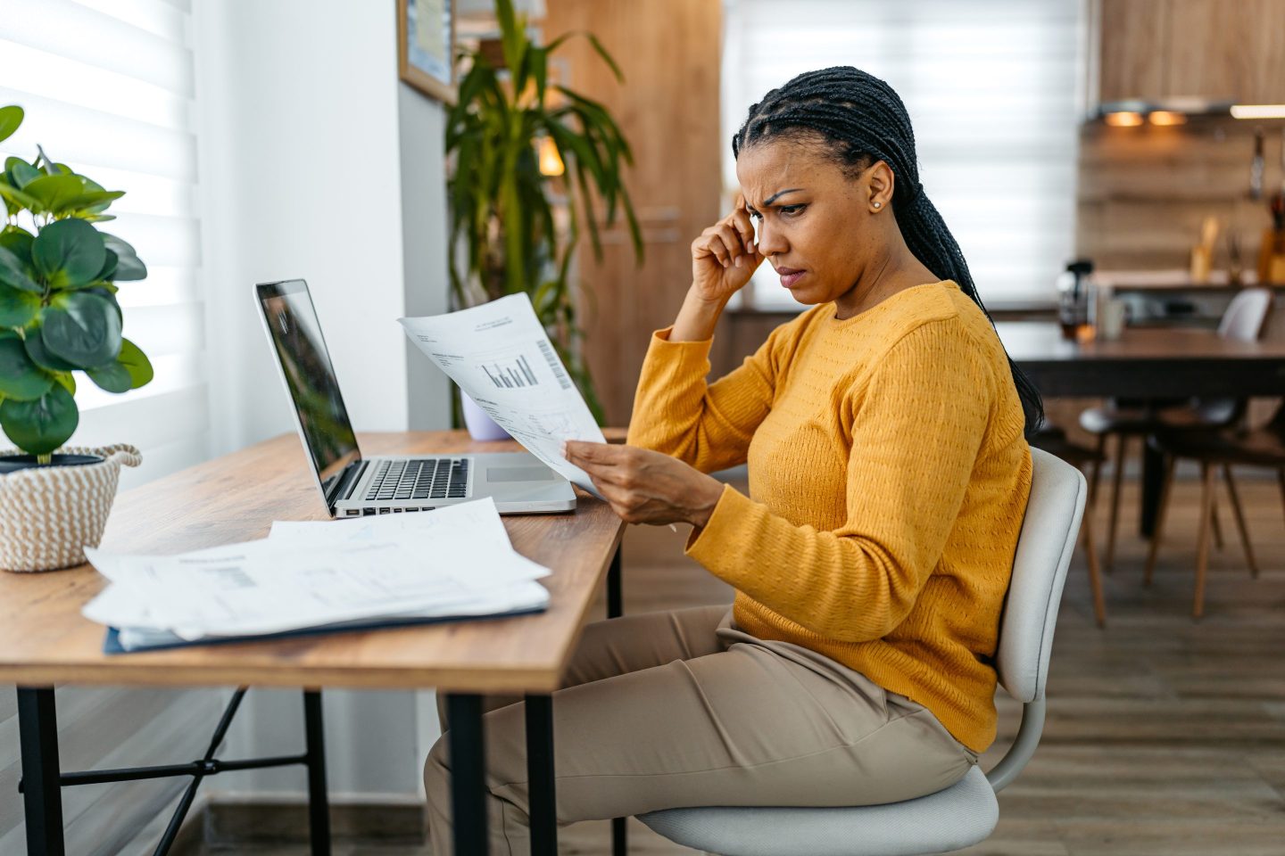 Worried Young Woman Checking Her Finances On A Laptop At Home.