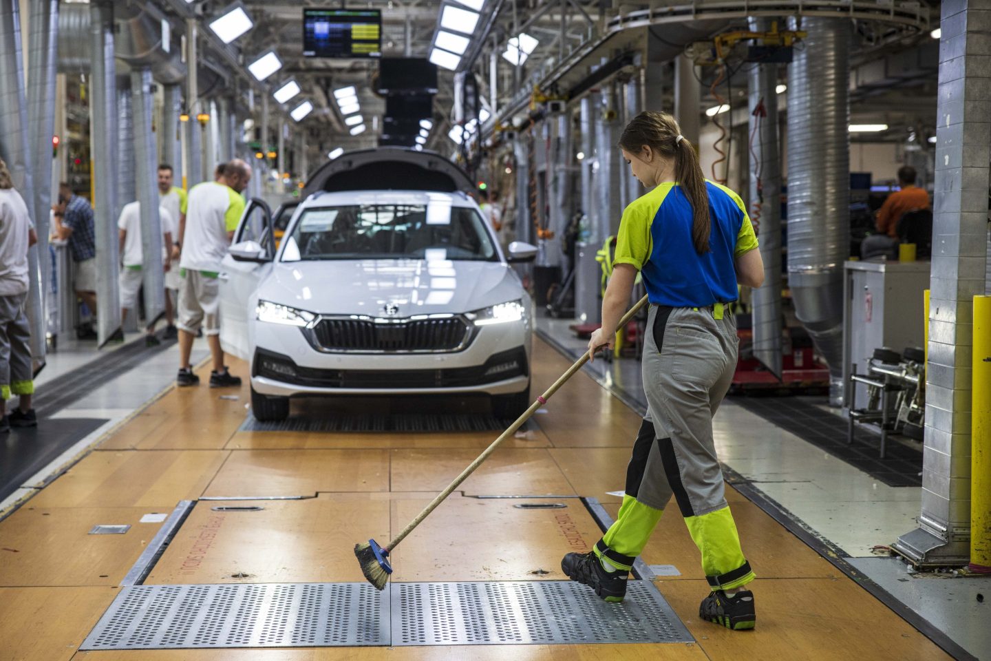A worker sweeps the floor on the production line at the Skoda Auto AS manufacturing plant in Mlada Boleslav, Czech Republic, on Monday, June 19, 2023. Volkswagen AG is set to outline broad plans to lift returns across its stable of mass-market brands as the carmaker seeks savings in the costly transition to electric cars.