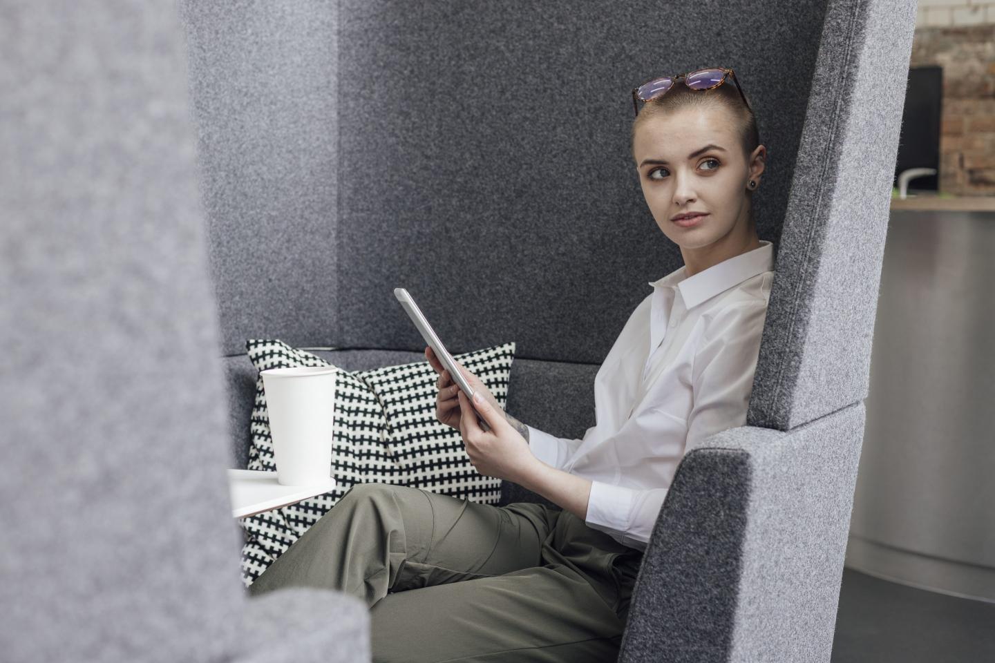 Young woman at work looking over her shoulder