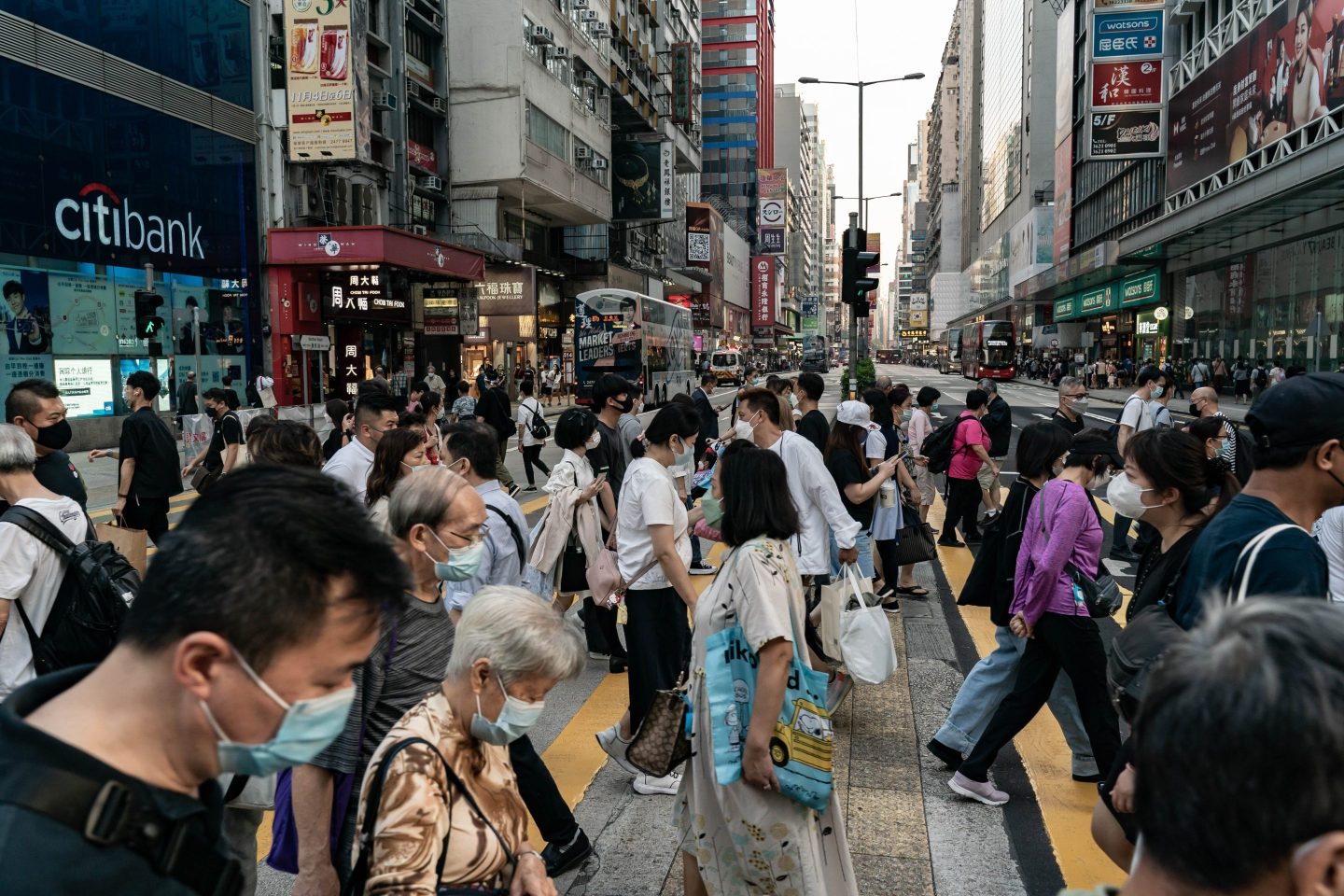 Residents cross an intersection at a shopping district on Oct. 24, 2022 in Hong Kong.