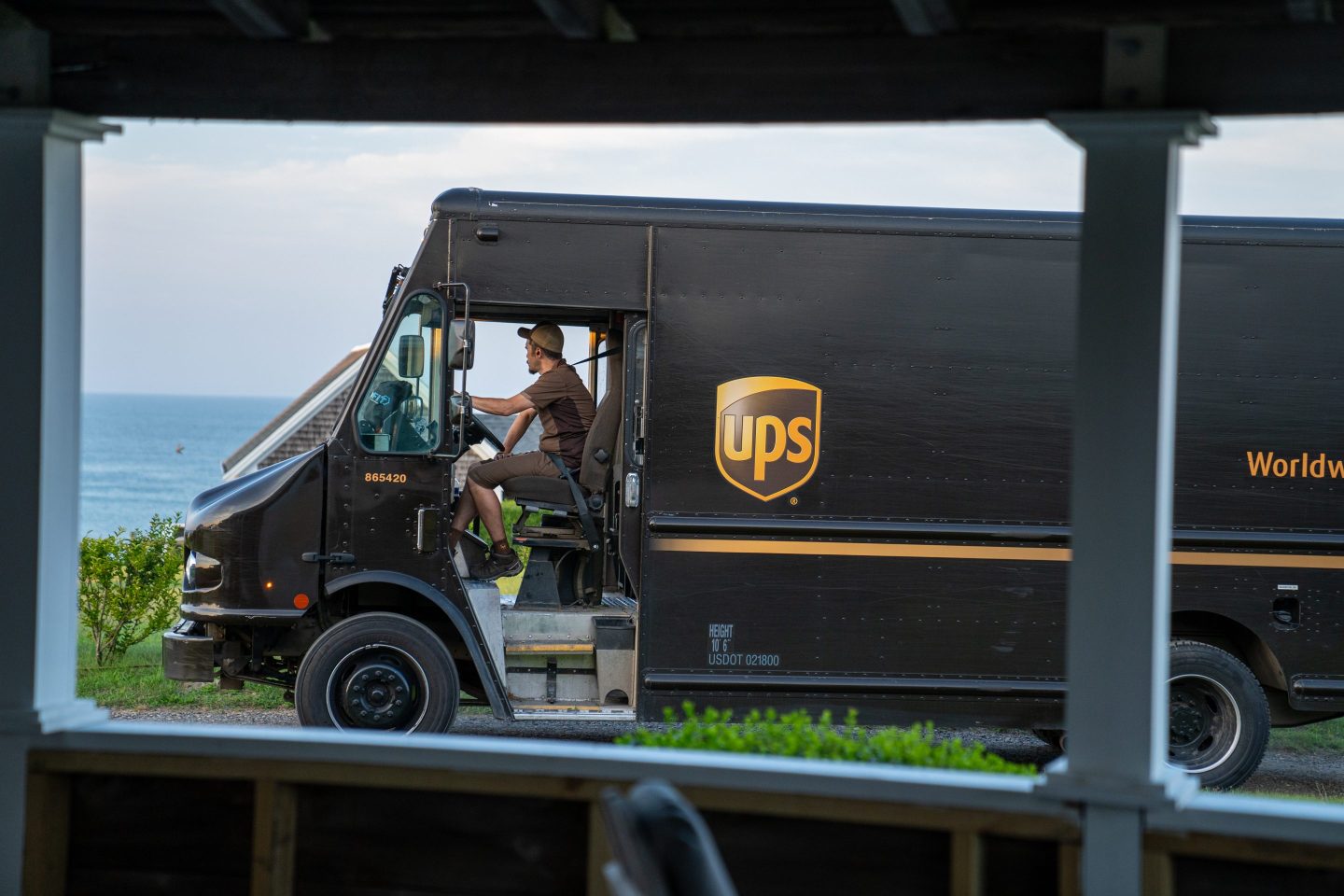 A United Parcel Service truck searches for a house while driving along the coast of Cape Cod