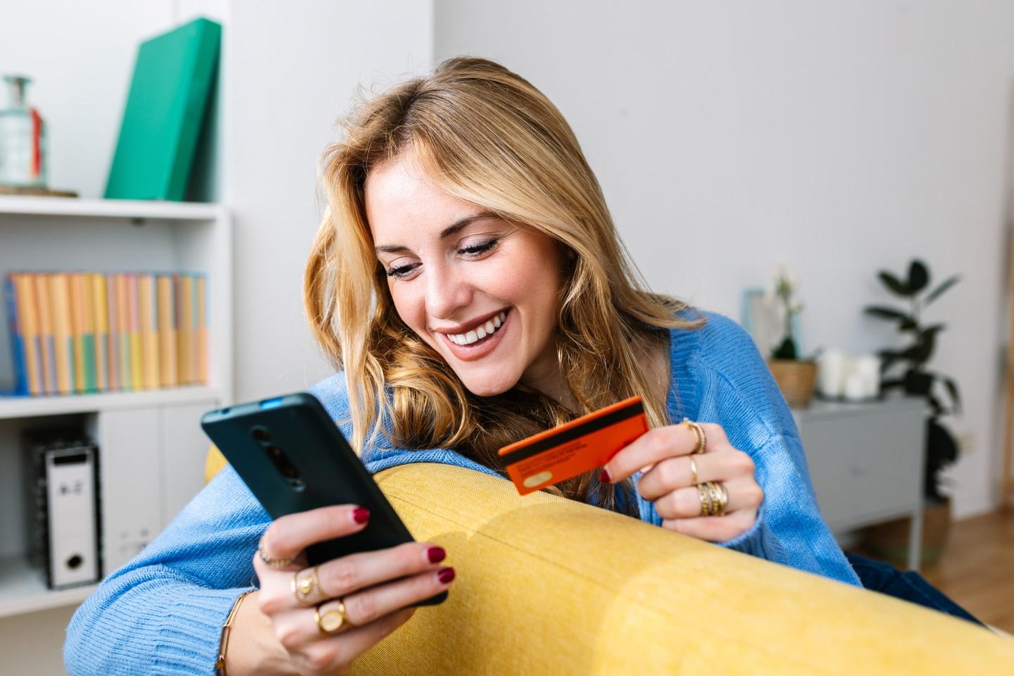 young woman making a purchase on her phone