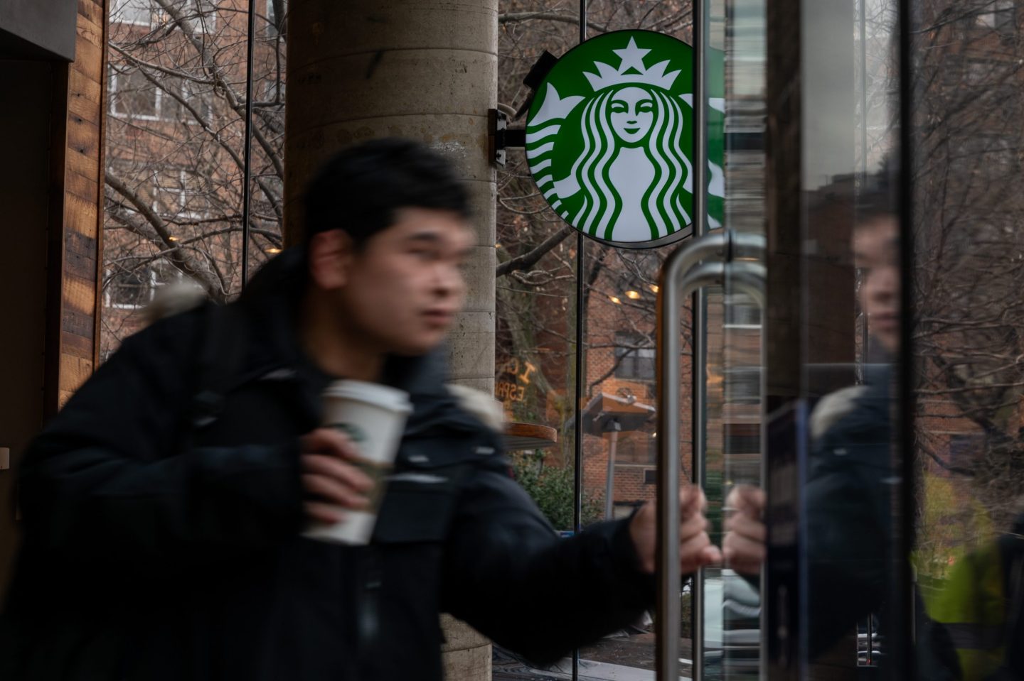 NEW YORK, NEW YORK - JANUARY 30: People exit a Starbucks store in Manhattan