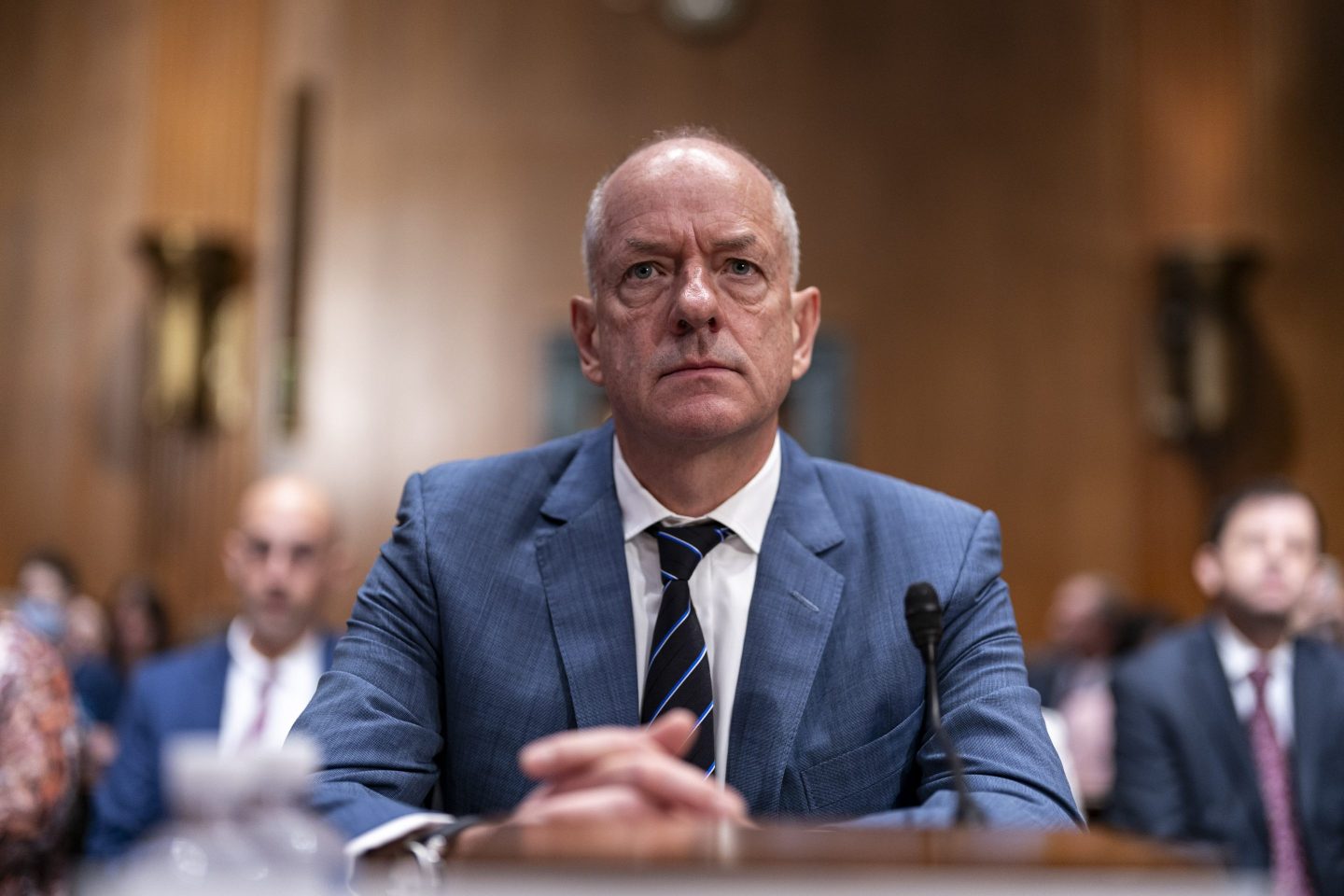 CEO of UnitedHealth Group sits in a blue suit testifying before Congress