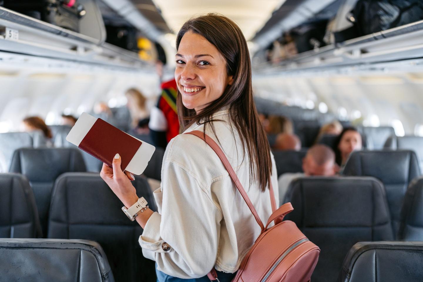 woman holding passport and boarding pass