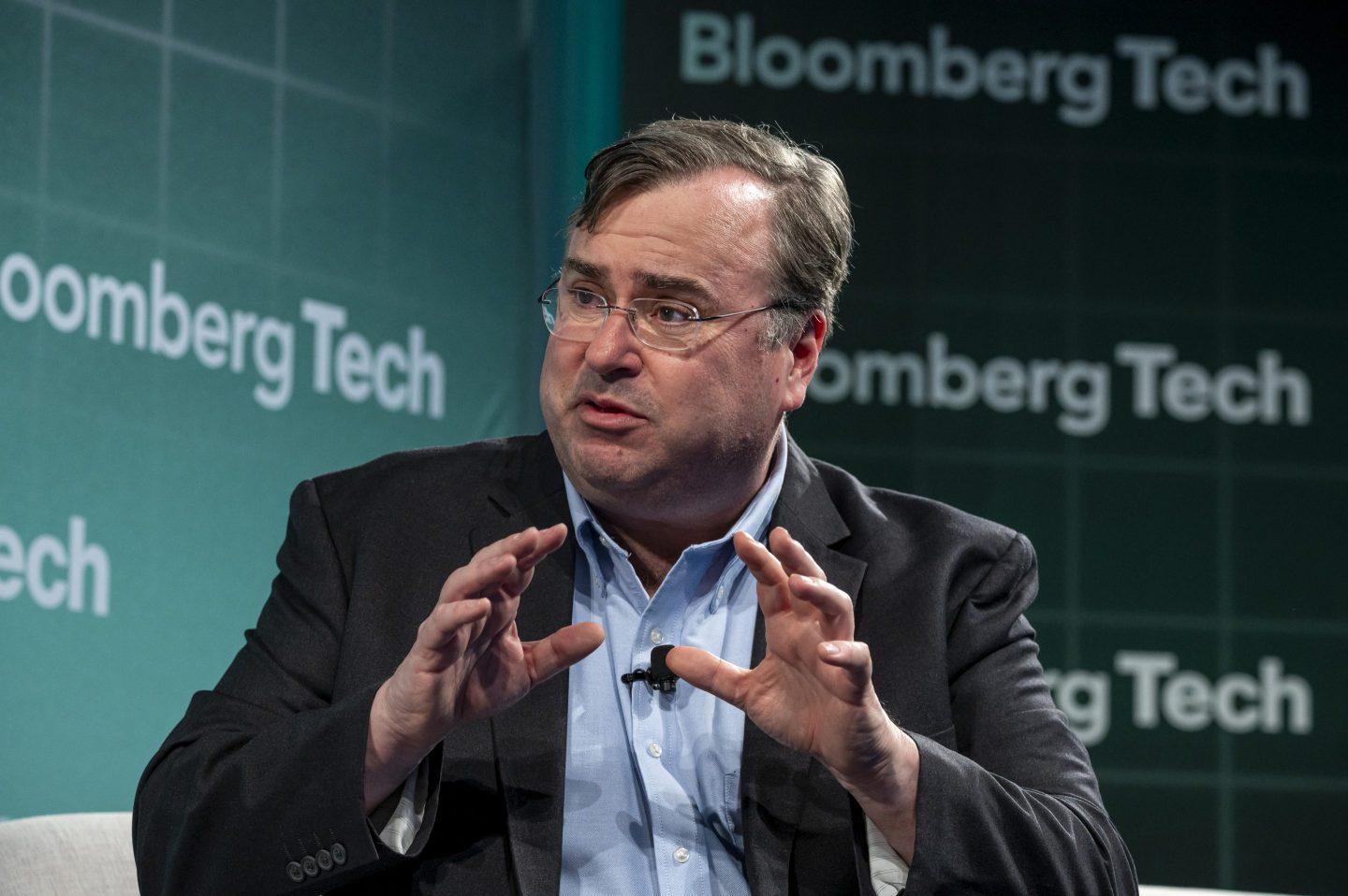 LinkedIn founder gesticulates on stage