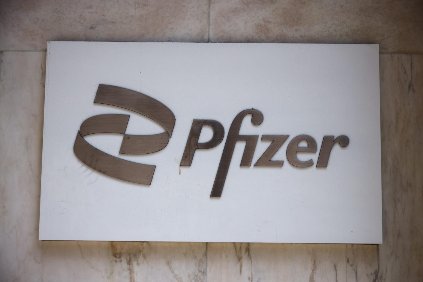 A white sign featuring the Pfizer logo