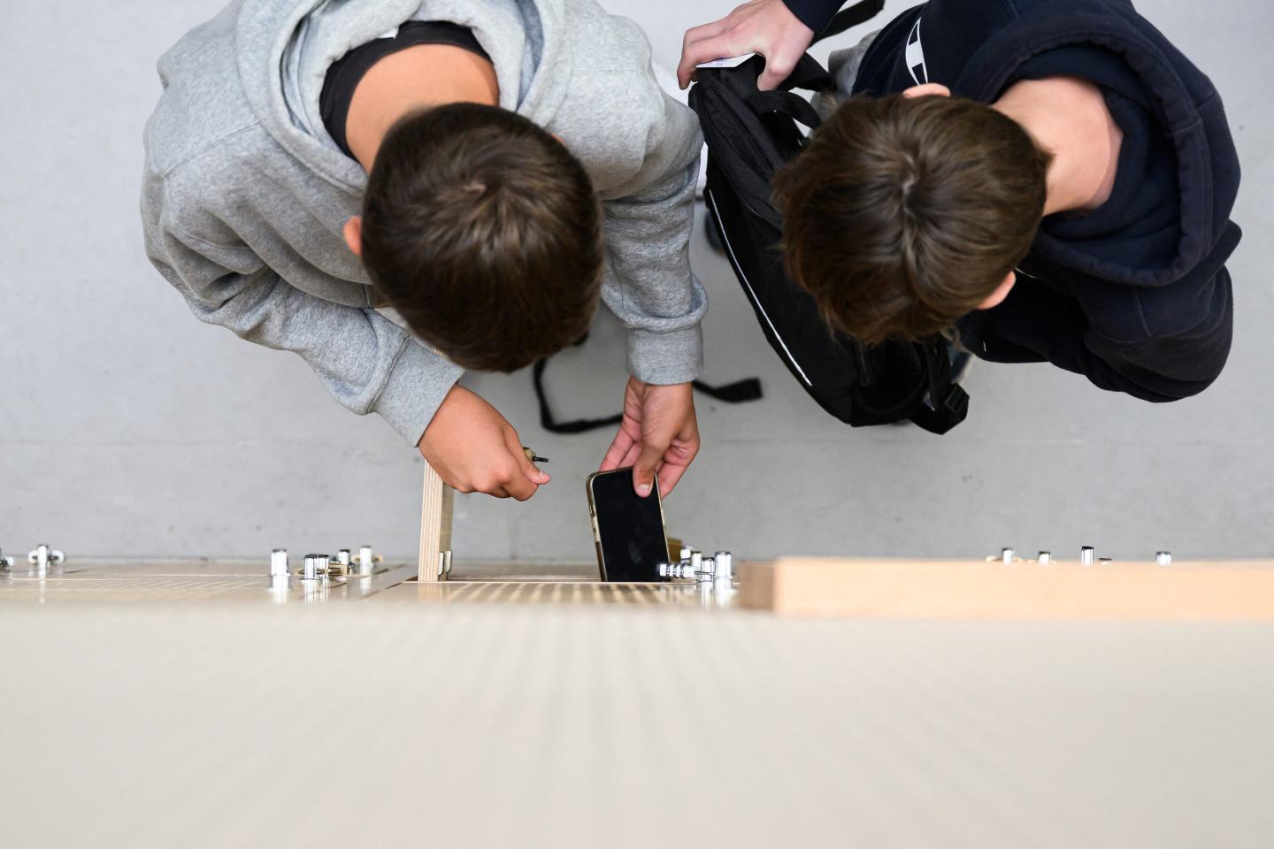 Students put their mobile phones in their lockers after switching them off