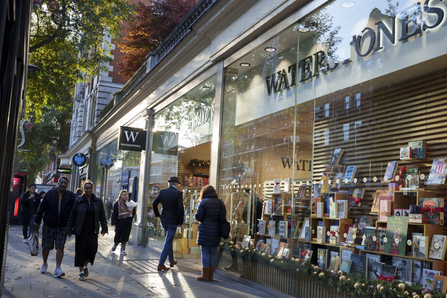 people walking in, out and near a Waterstones bookstore