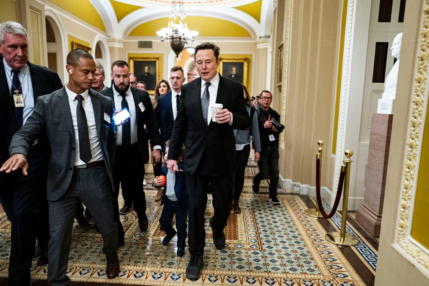 Elon Musk walking through the halls of Congress