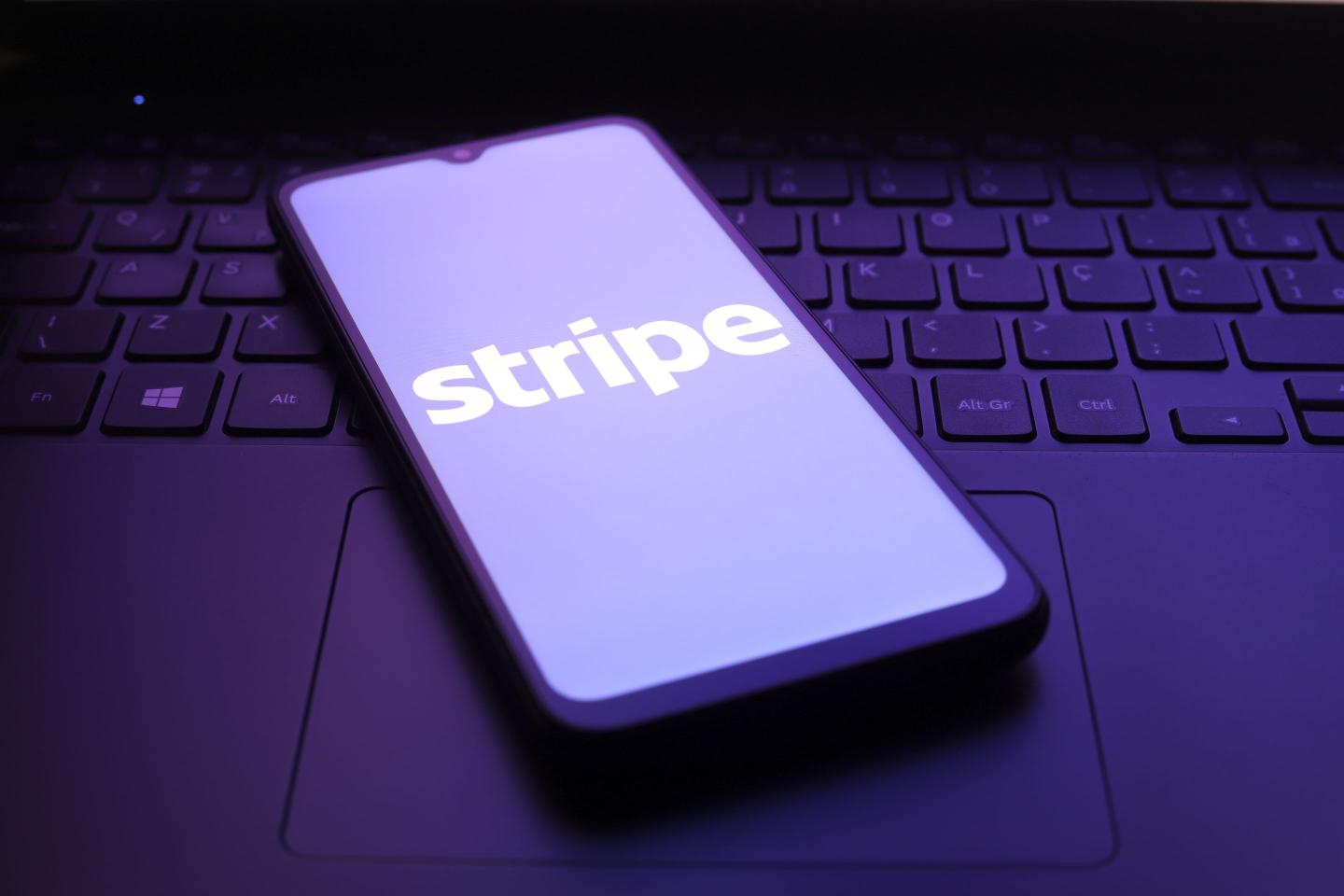 The Stripe logo appears on the screen of a smartphone