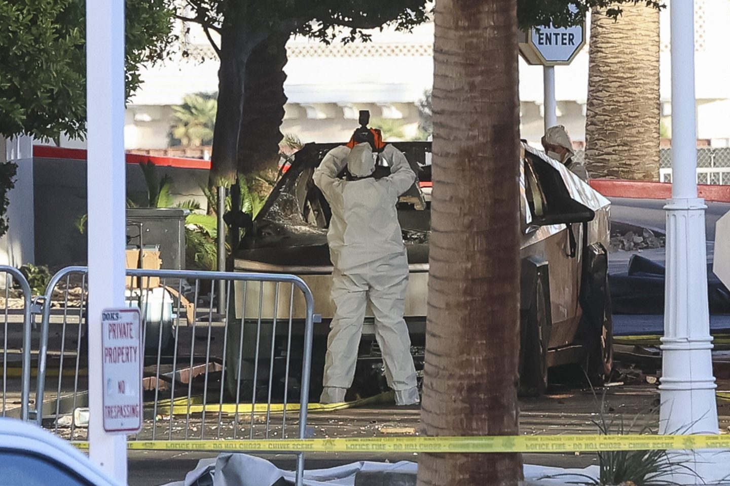 An investigator photographs a Tesla Cybertruck that exploded outside the lobby of President-elect Donald Trump's hotel on Jan. 1, 2025, in Las Vegas.
