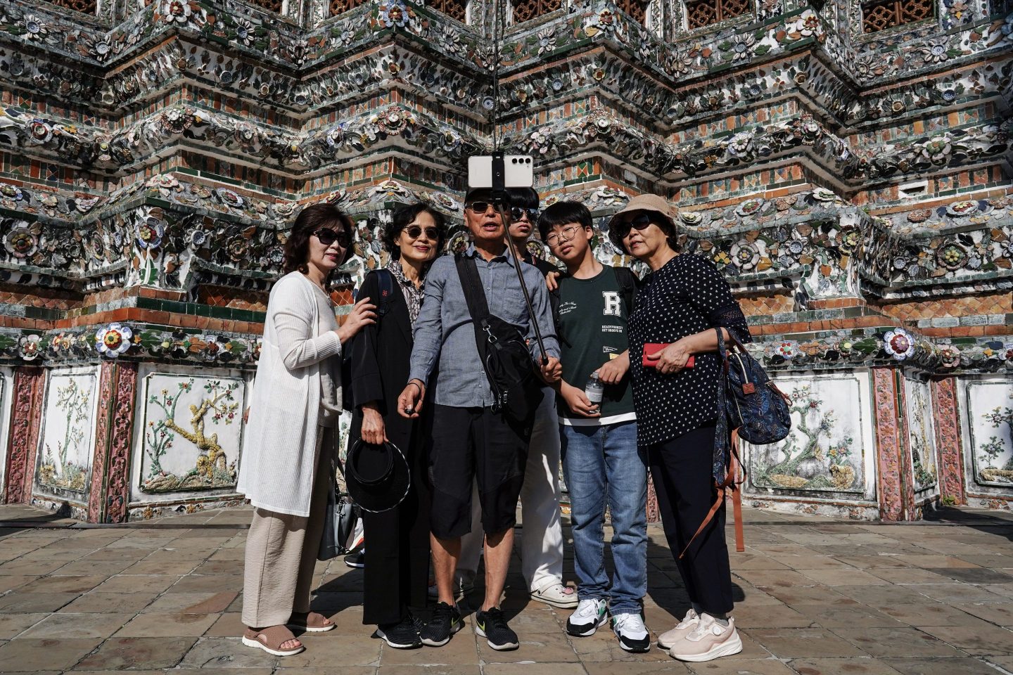 Chinese tourists take memorial photographs during their visit to Wat Arun, or the Temple of Dawn, in Bangkok on Jan. 13, 2025.