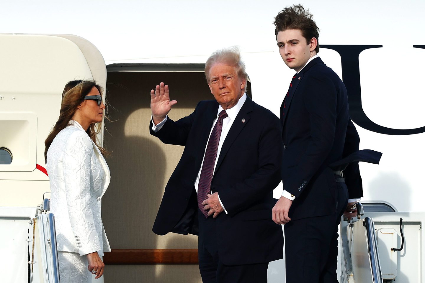 U.S. President-elect Donald Trump, Melania Trump and their son Barron board a U.S. Air Force aircraft en route to Dulles, Virginia on January 18, 2025 in West Palm Beach, Florida.