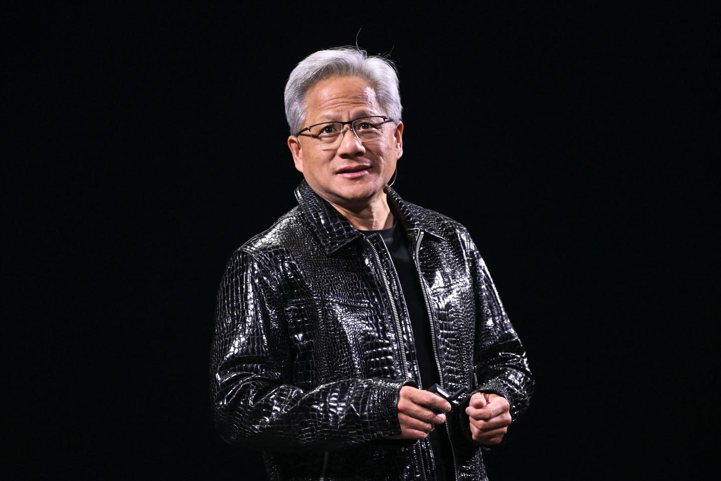 Nvidia's CEO Jensen Huang stands on stage at CES 2025