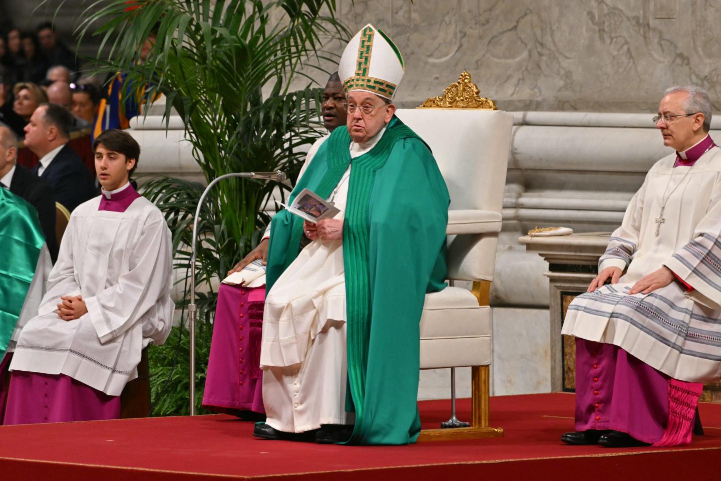 Pope Francis sits in chair during mass at St. Peter's Basilica.