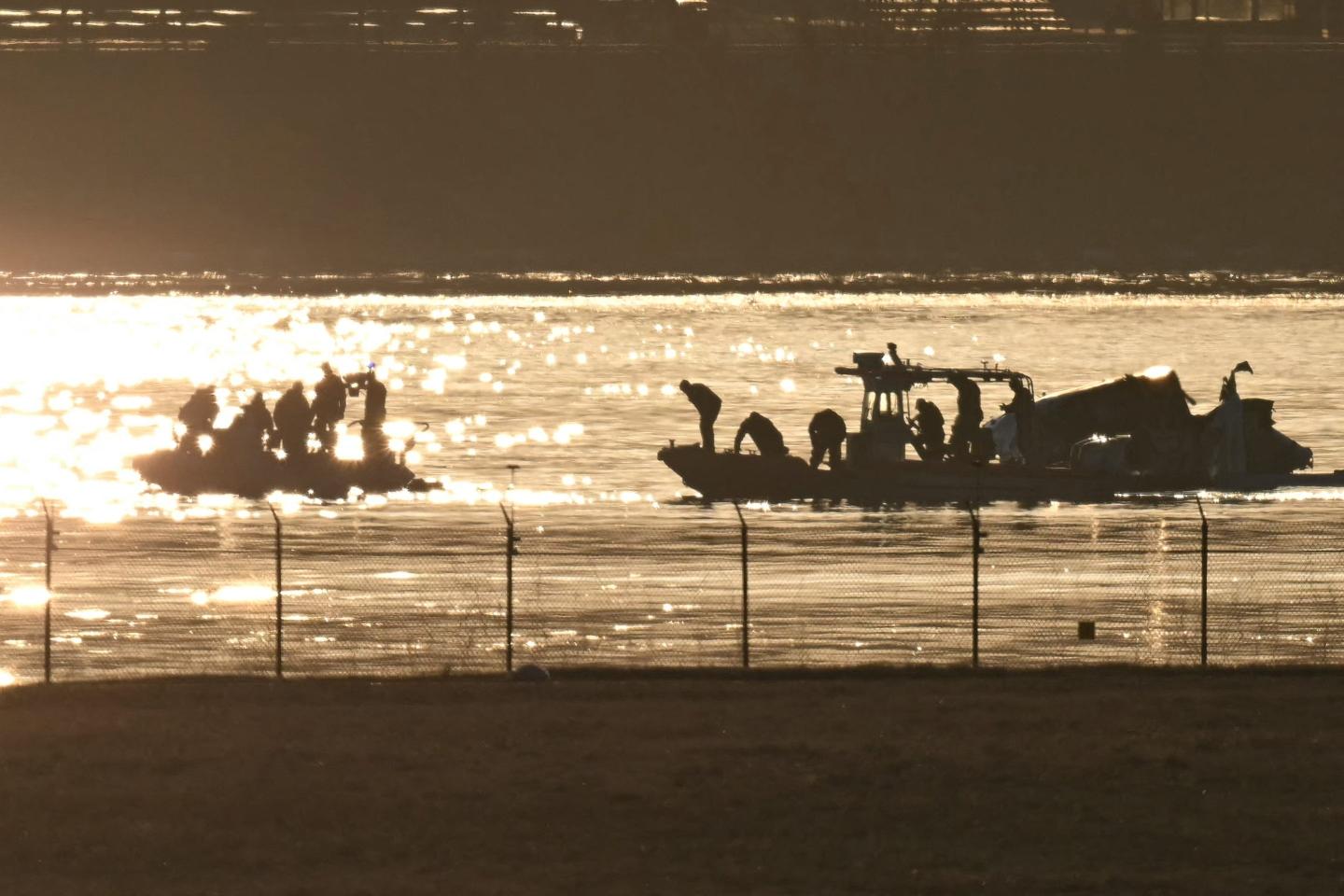 Part of the wreckage is seen as rescue crews search the waters of the Potomac River after a passenger plane on approach to Reagan National Airport crashed into the river
