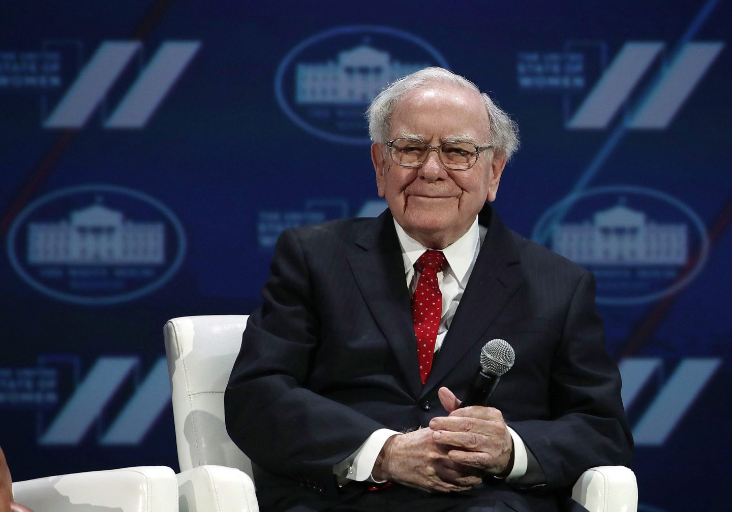 Warren Buffett holding a microphone