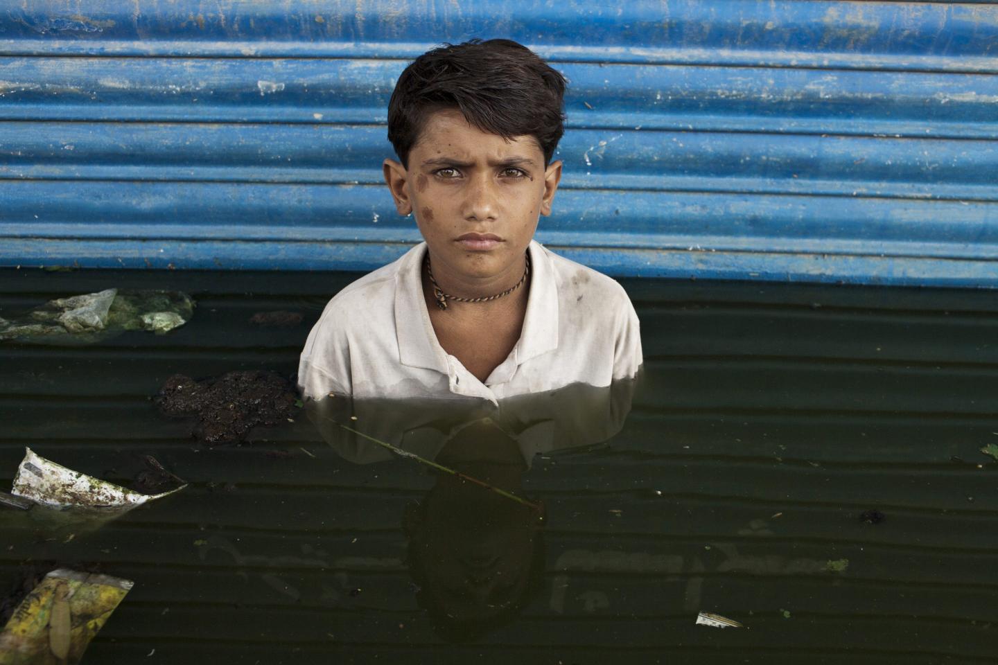 Portrait of child in floodwaters