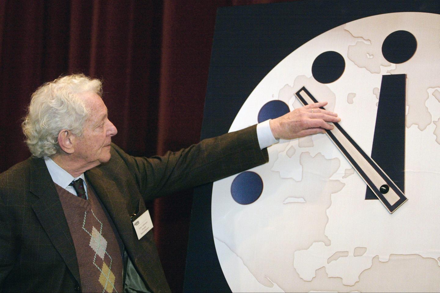 Physics Nobel Prize winner Dr. Leon M. Lederman moves the hands of the Bulletin of the Atomic Scientists "Doomsday Clock"