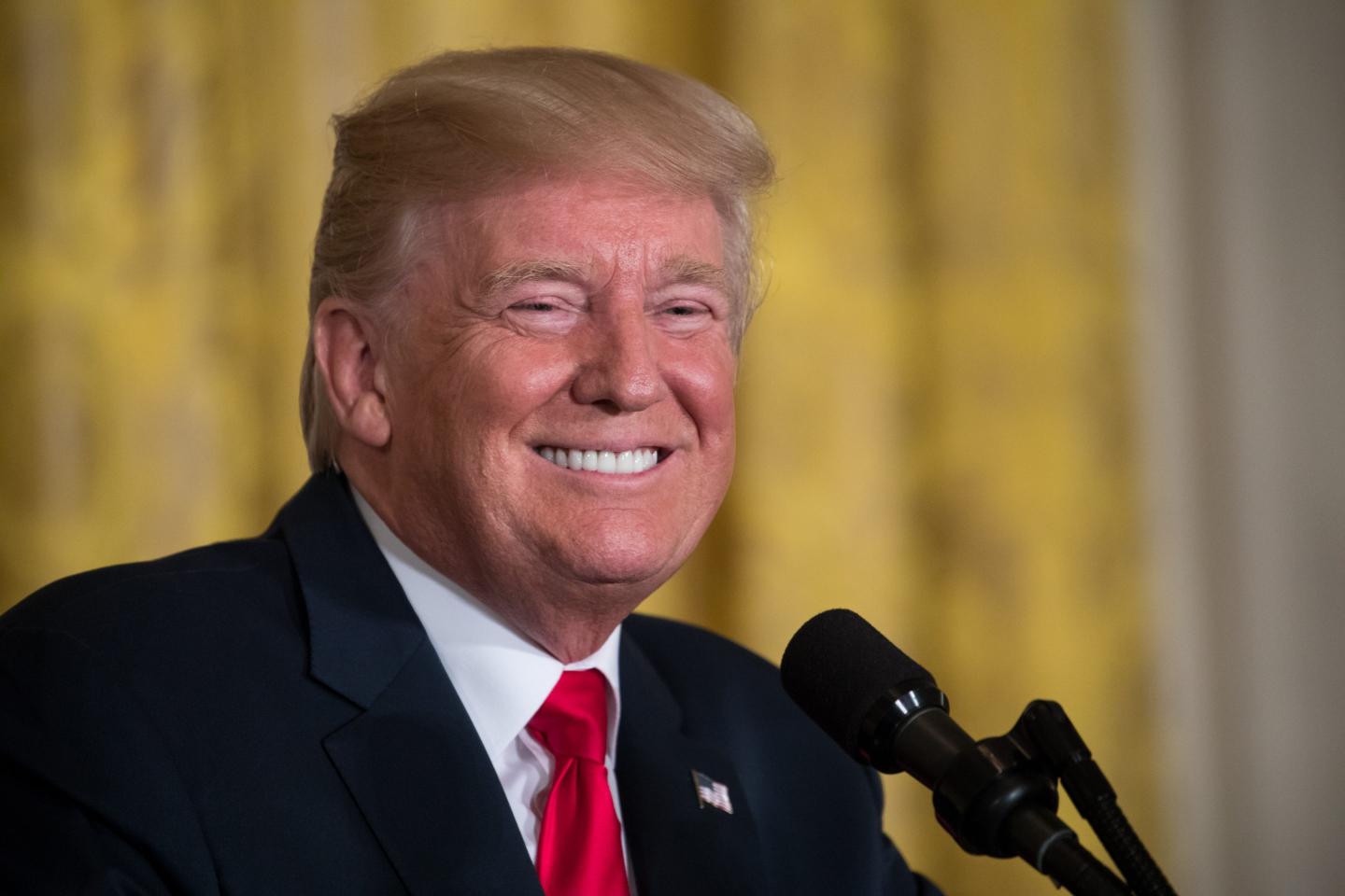 Donald Trump smiling at a podium