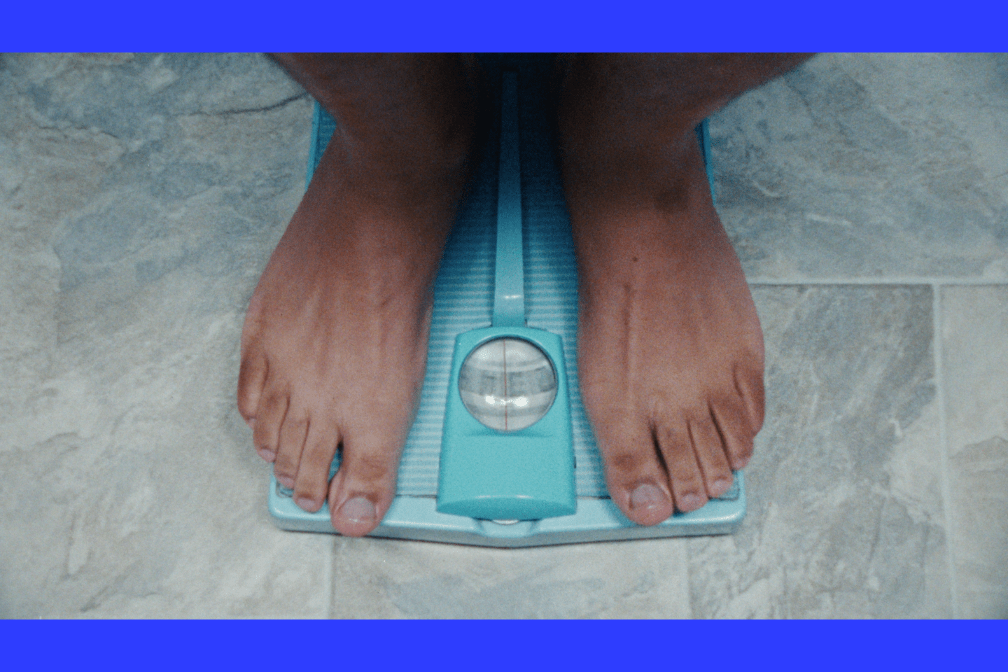 A person stands on a scale.