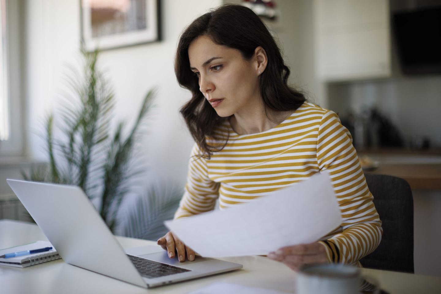 Serious young woman working at home.