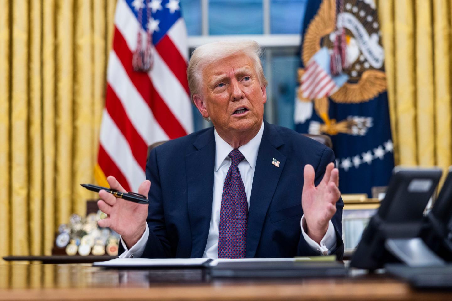 US President Donald Trump speaks while signing executive orders in the Oval Office of the White House