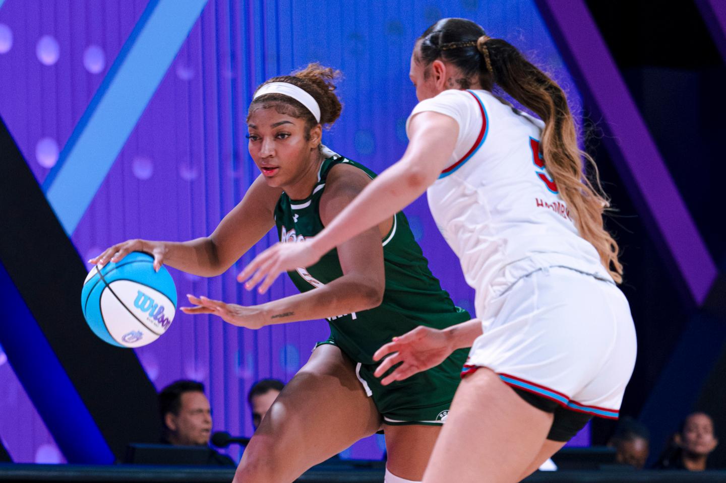 two basketball players playing on the court
