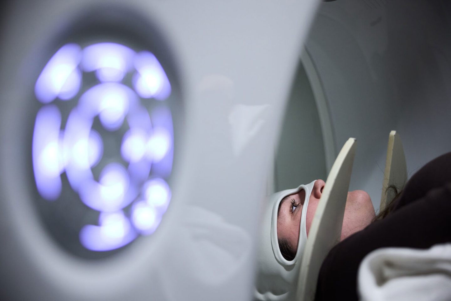 A young woman undergoes a brain scan.