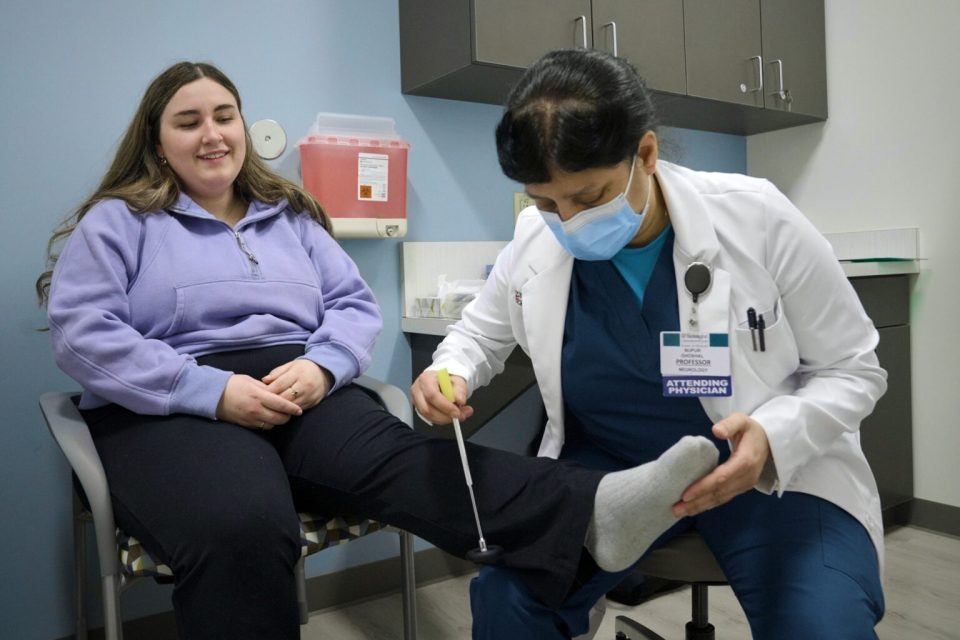 A doctor examines a patient for a clinical trial.
