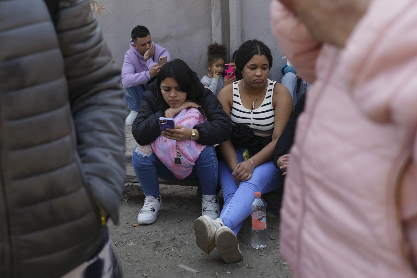 Migrants wait outside the Mexican Commission for Refugee Aid (COMAR) government office to apply for asylum in Mexico City, on Jan. 28, 2025.