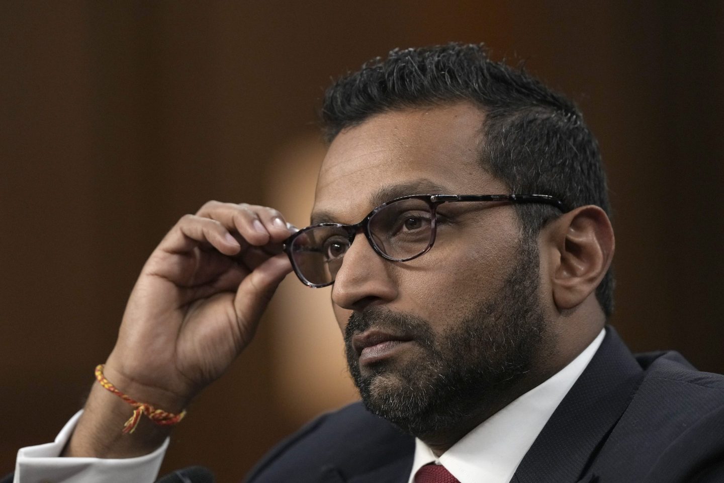 Kash Patel adjusts his glasses