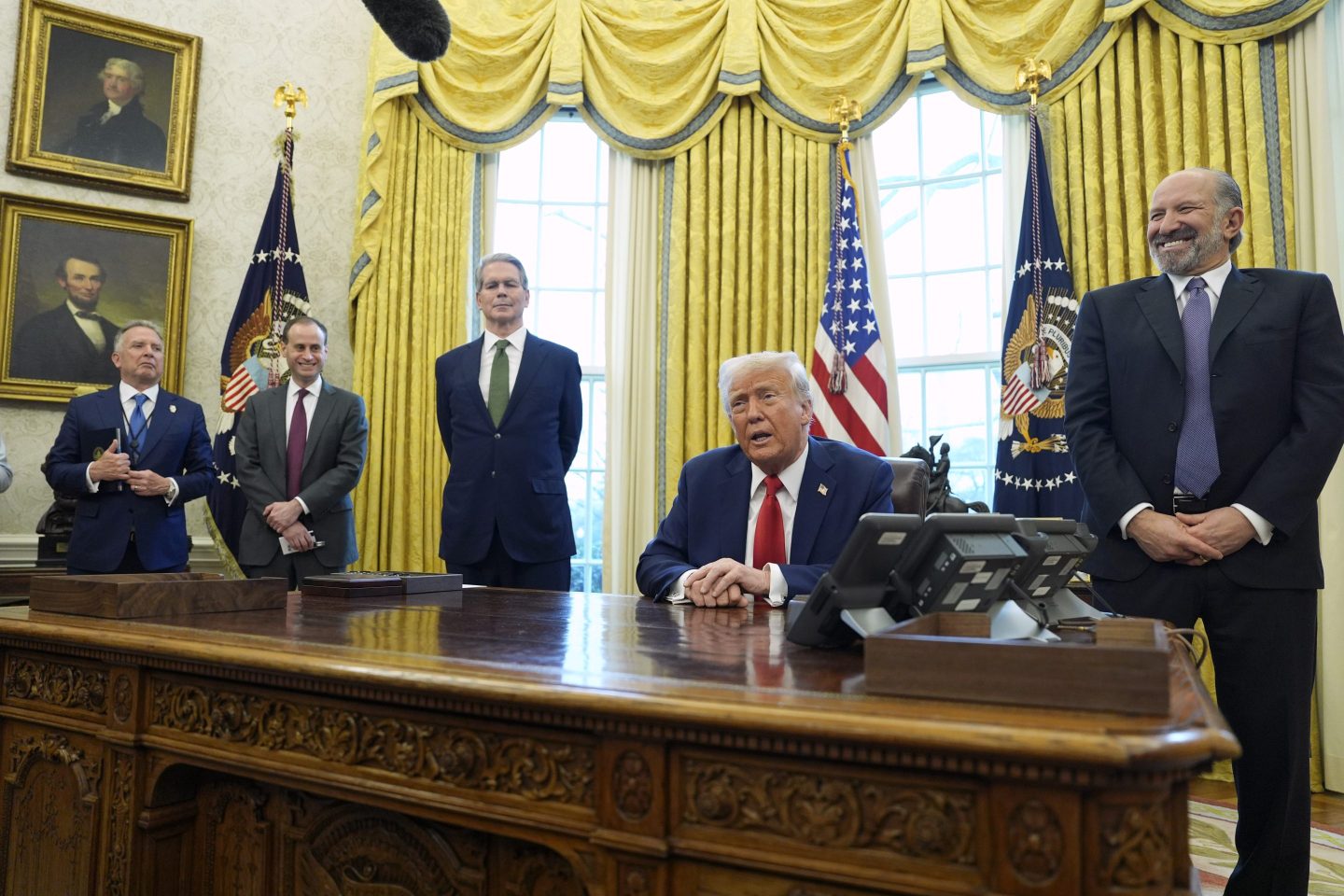 President Donald Trump speaks as Steve Witkoff, special envoy for the Middle East, from left, White House staff secretary Will Scharf, Treasury Secretary Scott Bessent and Commerce Secretary nominee Howard Lutnick listen as Trump signs executive orders in the Oval Office of the White House, on Feb. 3, 2025, in Washington.