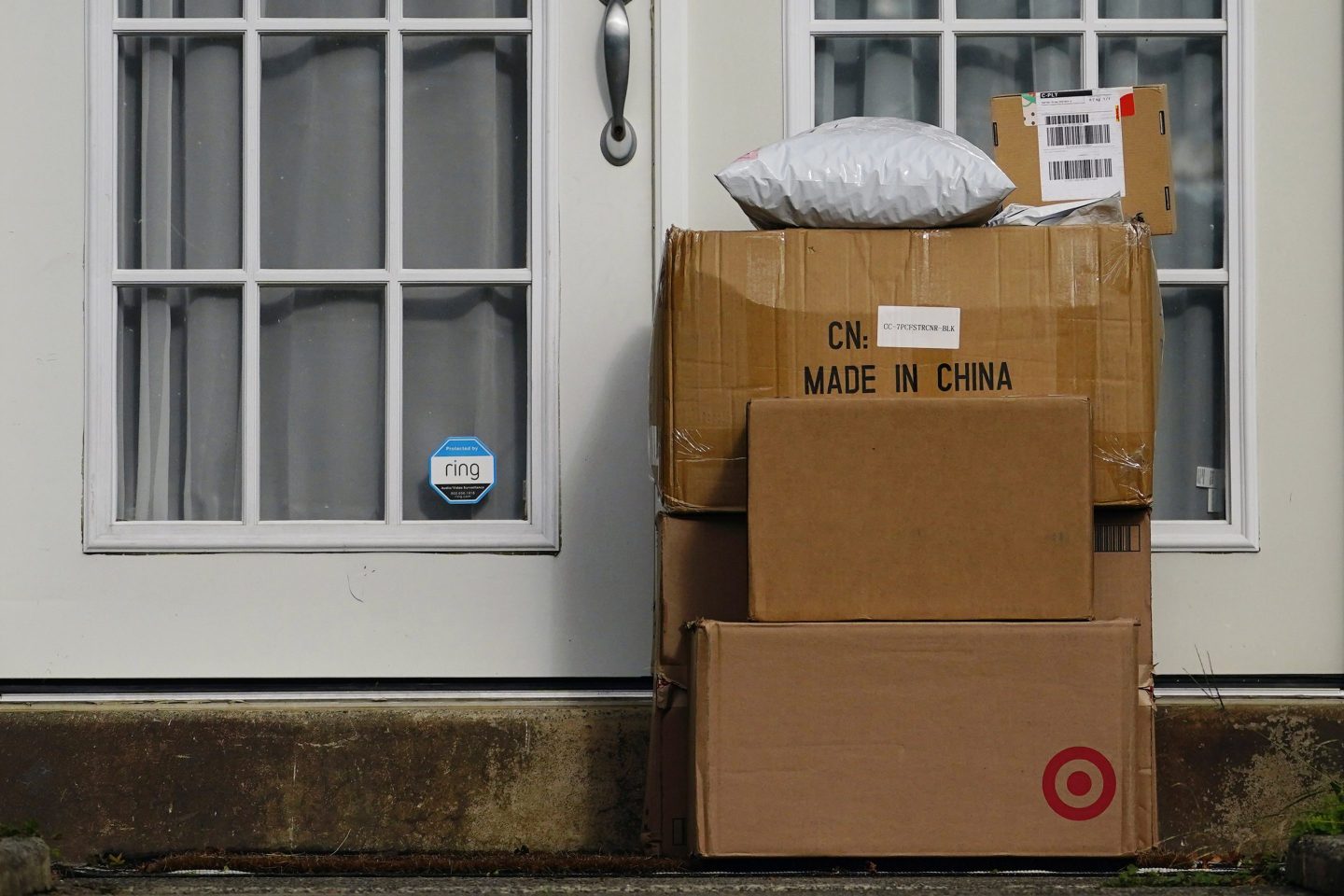 Packages are seen stacked on the doorstep of a residence, on Oct. 27, 2021, in Upper Darby, Pa.