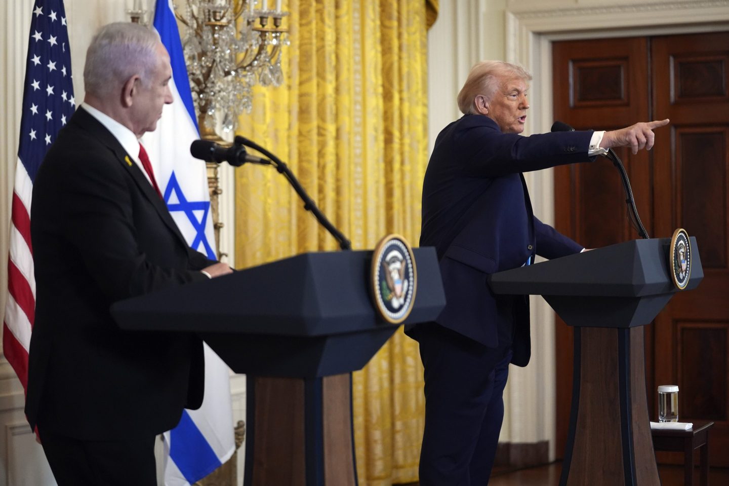 President Donald Trump calls on a reporter for a question as Israel's Prime Minister Benjamin Netanyahu watches during a news conference in the East Room of the White House, on Feb. 4, 2025, in Washington.