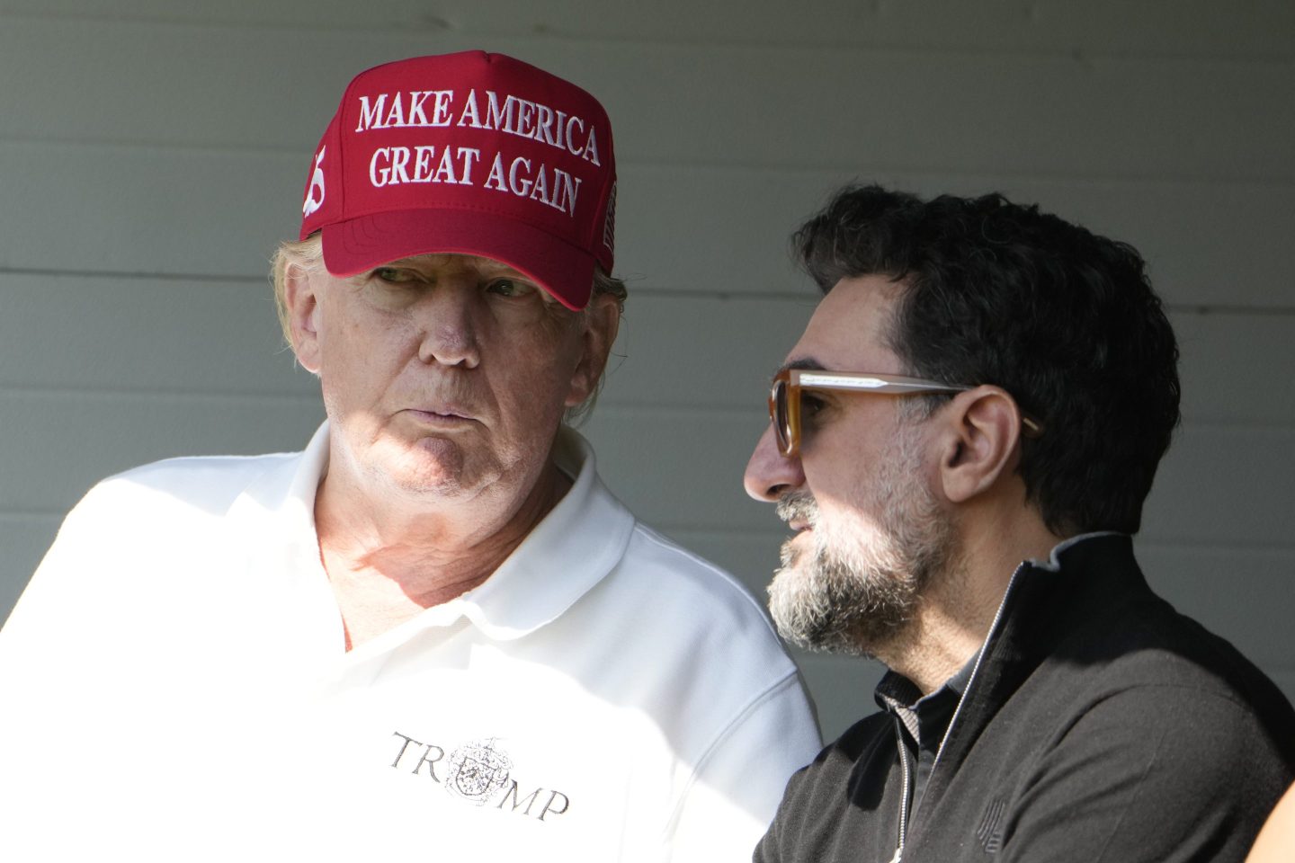 Trump speaks with the governor of Saudi Arabia's Public Investment Fund (PIV) at a golf tournament