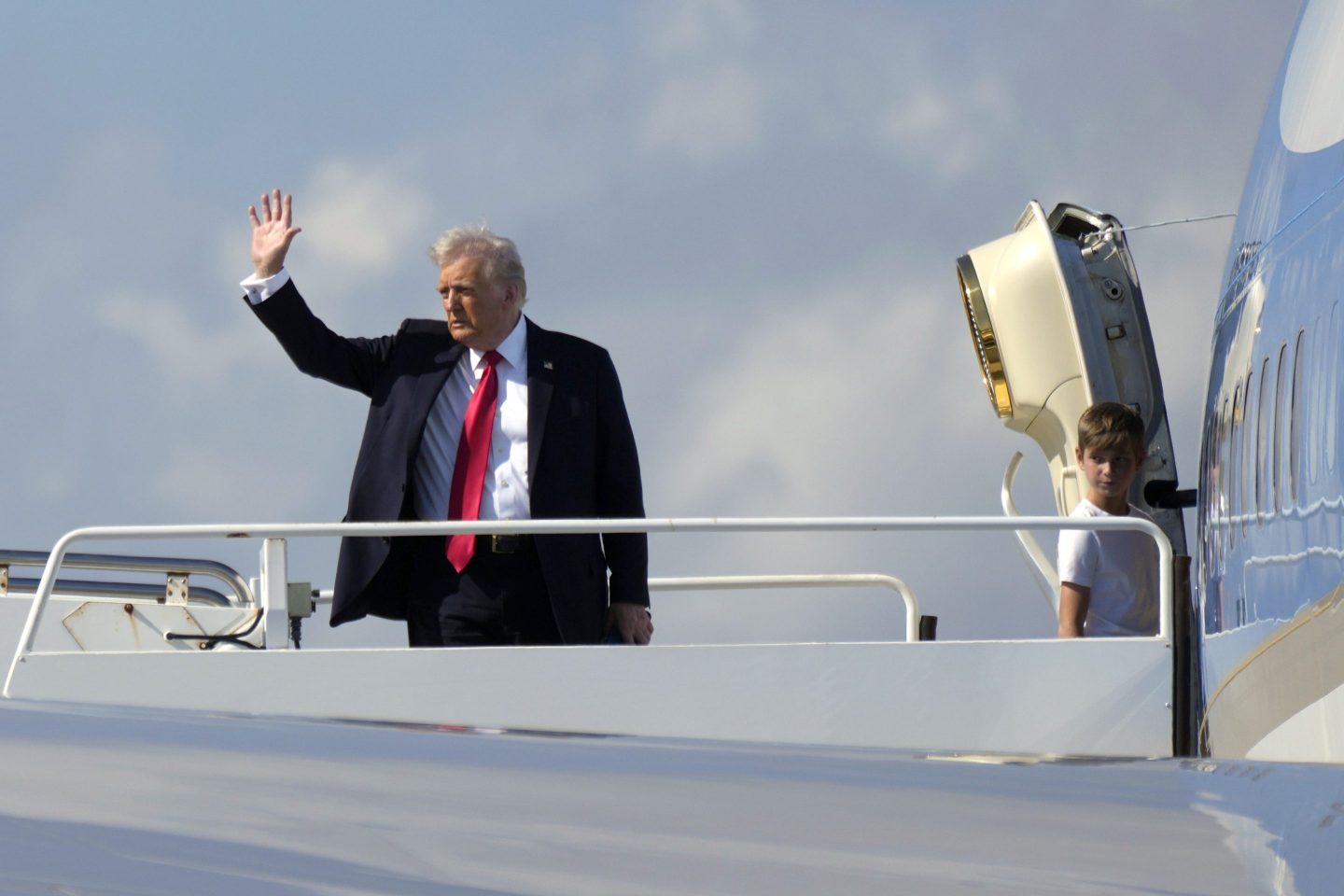 President Donald Trump boards Air Force One at Palm Beach International Airport on Sunday.