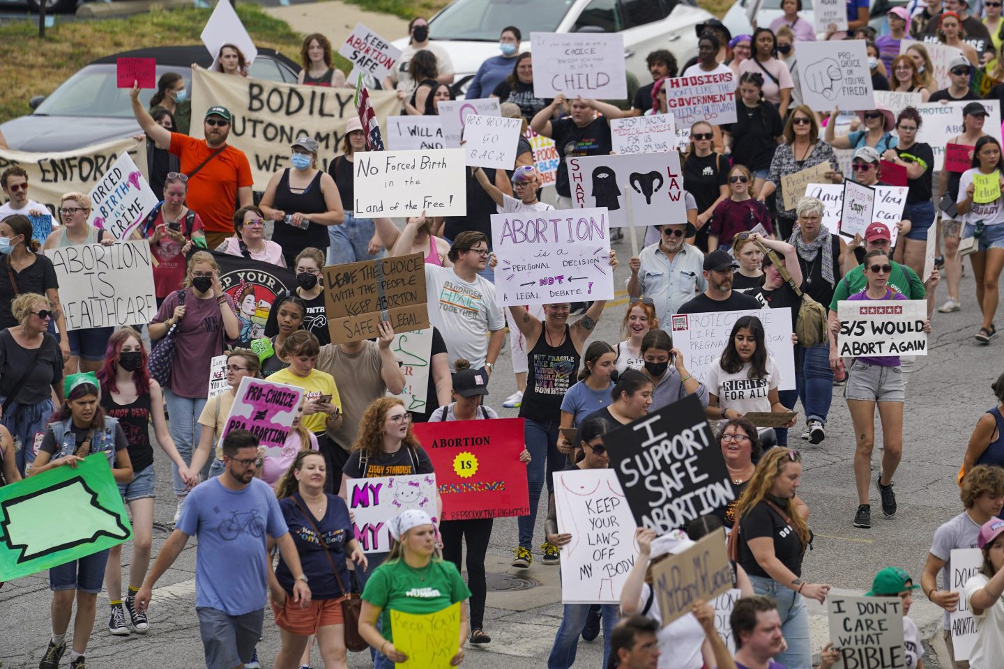 Abortion-rights protestors march between the Indiana Statehouse and the Indiana State Library where Vice President Kamala Harris was meeting with Indiana legislators to discuss reproductive rights, July 25, 2022, in Indianapolis.