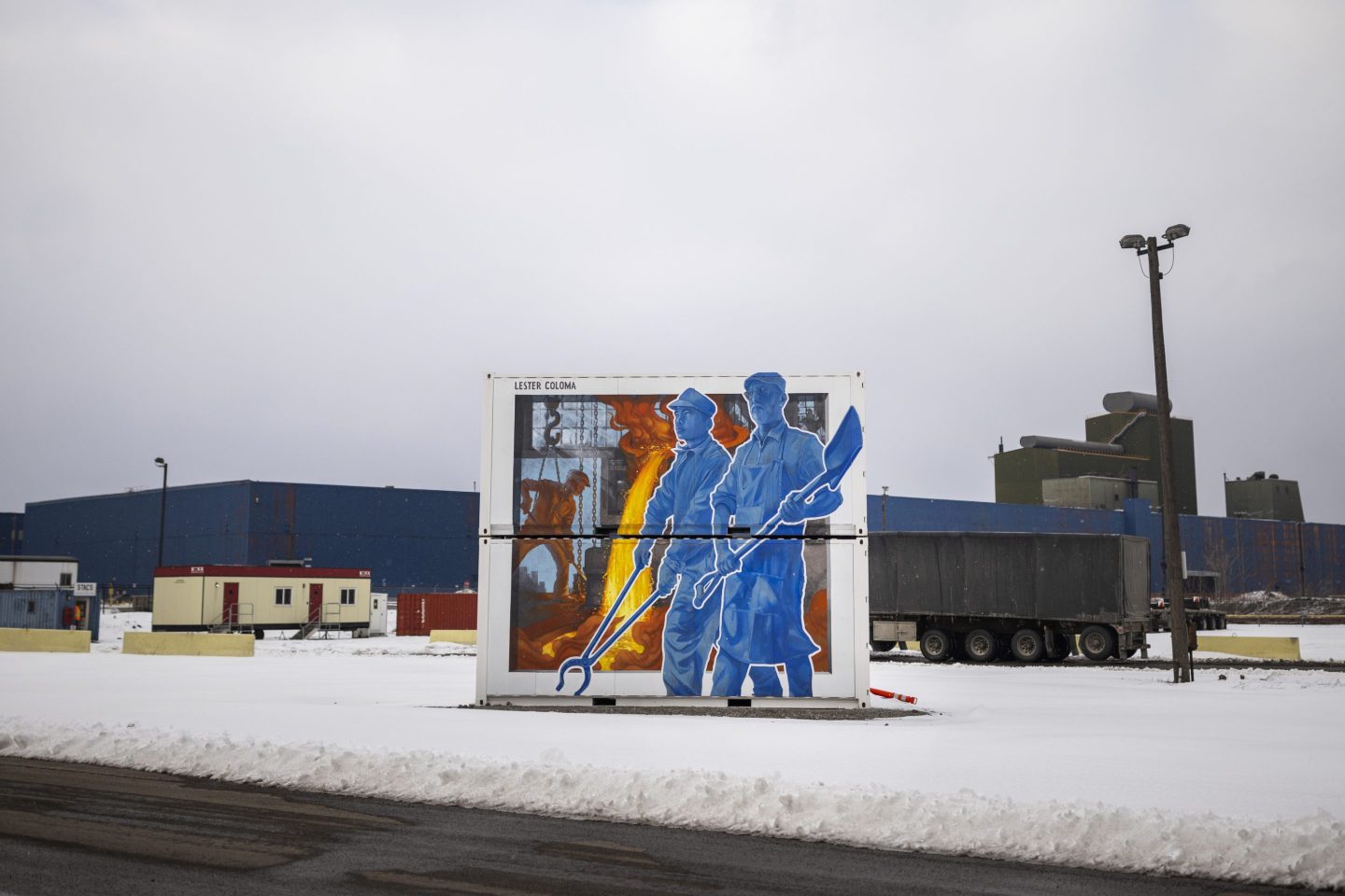 A mural depicting steel workers stands at the Stelco steel production facility in Hamilton, Ontario, on Feb. 10, 2025.